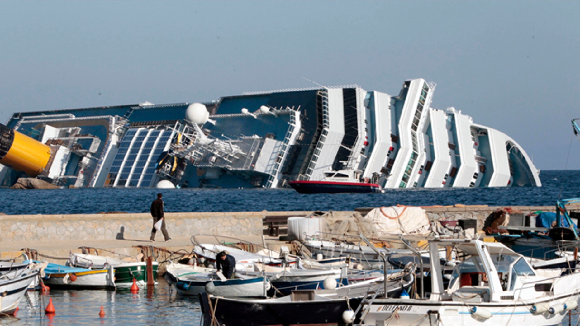 Jan. 14, 2012: The luxury cruise ship Costa Concordia leans on its starboard side as seen from the Giglio harbor, after running aground off the tiny Tuscan island of Giglio, Italy. The luxury cruise ship ran aground off the coast of Tuscany, sending water pouring in through a 160-foot (50-meter) gash in the hull and forcing the evacuation of some 4,200 people from the listing vessel early Saturday, the Italian coast guard said. The number of dead and injured is not yet confirmed Coast Guard Cmdr. Francesco Paolillo said. (AP Photo/Gregorio Borgia)
