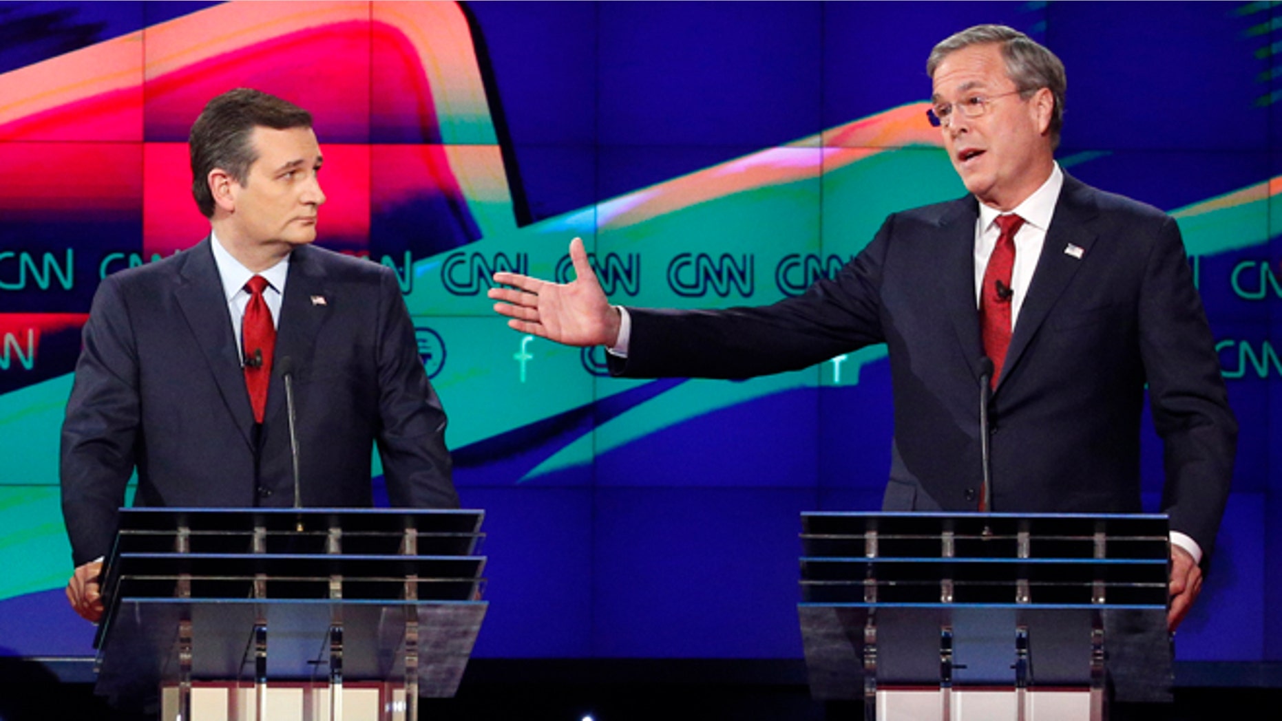 FILE - In this Dec. 15, 2015 file photo, former Florida Gov. Jeb Bush, right, makes a point as Sen. Ted Cruz, R-Texas listens on during the Republican presidential debate in Las Vegas. Ted Cruz once proudly wore a belt buckle reading President of the United States borrowed from George H.W. Bush. He campaigned and worked for, and helped write a book lavishing praise on, that former presidents son, Dubya. And the endorsement of George P. Bush, the familys latest rising political star, lent credibility to Cruzs then little-known 2012 Senate campaign. (AP Photo/John Locher, File)