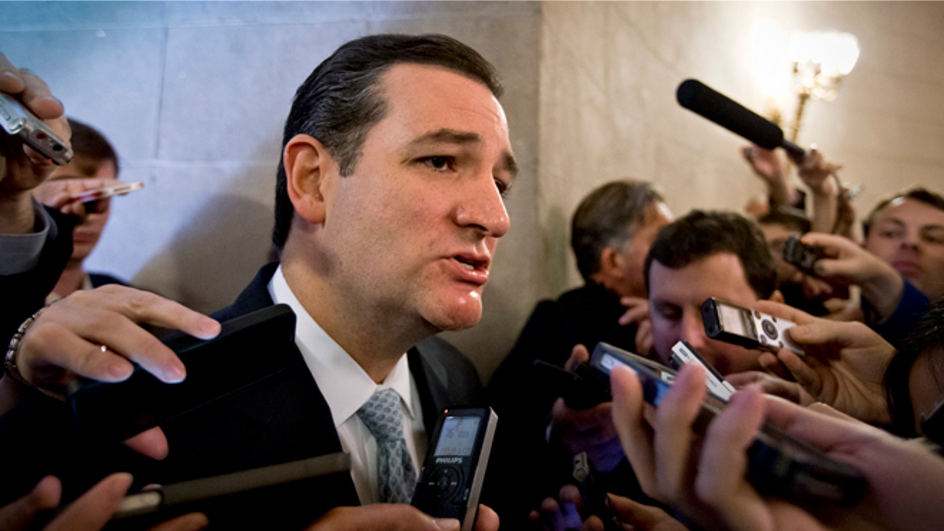 Wednesday, Oct. 16, 2013: Sen. Ted Cruz, R-Texas, speaks to reporters waiting outside a closed-door meeting of Senate Republicans, on Capitol Hill in Washington, D.C.