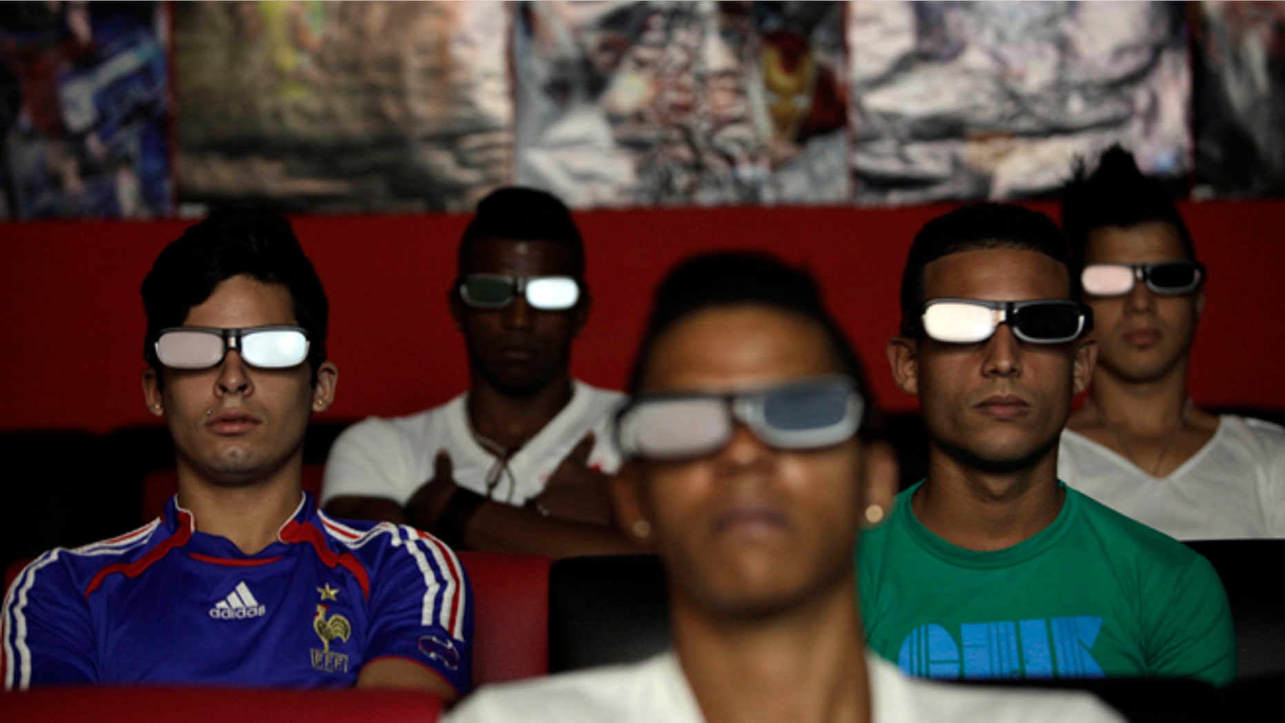People watch a 3D movie at a private movie theater in Havana, Cuba, Monday, Oct. 28, 2013. Cuban entrepreneurs have quietly opened dozens of backroom video salons over the last year, seizing on ambiguities in licensing laws to transform cafes and childrenâs entertainment parlors into a new breed of private business unforeseen by recent official openings in the communist economy. (AP Photo/Franklin Reyes)