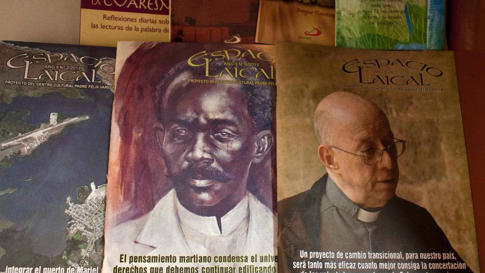 This June 25, 2014, photo, shows issues of the Roman Catholic magazine Espacio Laical exhibited for sale in a small shop in Old Havana, Cuba. The editors of the magazine, Roberto Veiga and Lenier Gonzalez resigned in early May, later confirming they quit because the magazine's content was controversial in the ecclesiastical community. The magazine’s director, Gustavo Andujar, said the editors left voluntarily. (AP Photo/Franklin Reyes)