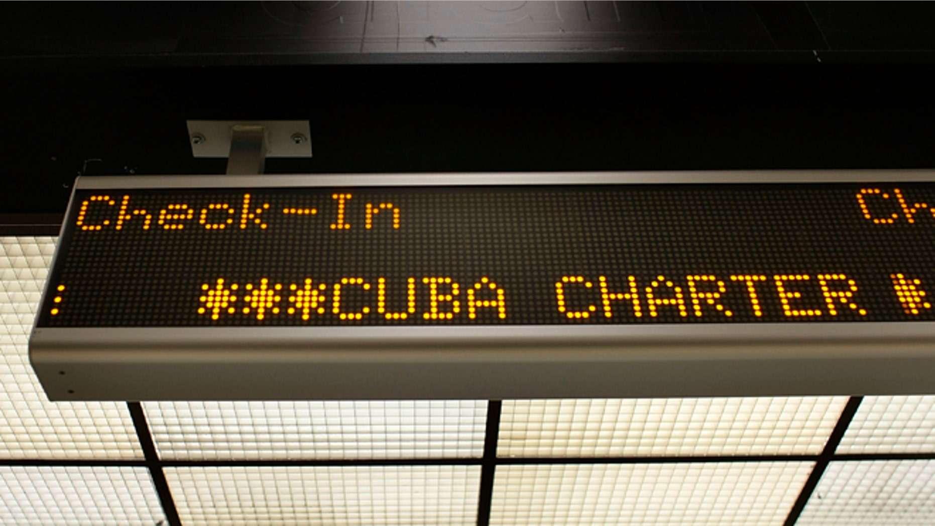 MIAMI - APRIL 07: A check-in sign for the ABC Charter flight to Cuba is seen at Miami International Airport on April 7, 2009 in Miami, Florida. Reports indicate that U.S. President Barack Obama plans to loosen restrictions on family travel and remittances to Cuba. (Photo by Joe Raedle/Getty Images)