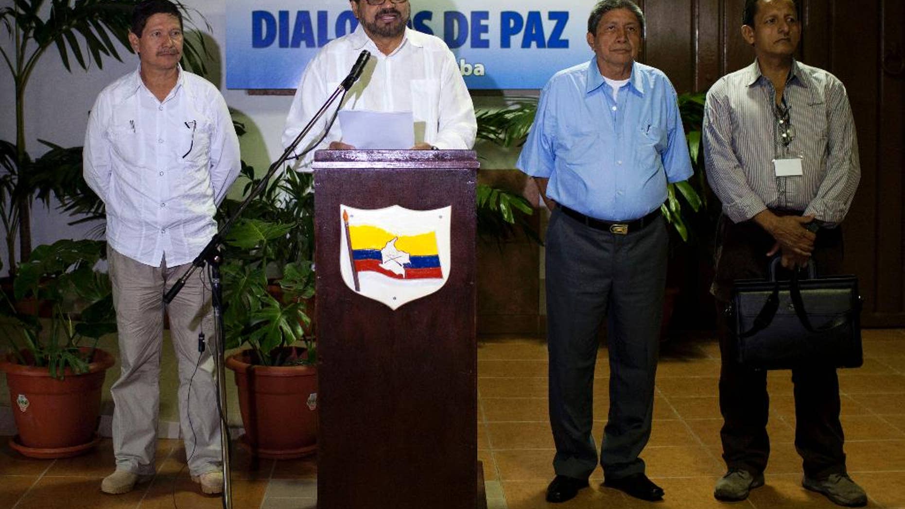 FILE - In this Feb. 28, 2014 file photo, Ivan Marquez, chief negotiator for the Revolutionary Armed Forces of Colombia, or FARC, center, speaks to journalists accompanied by Commander Fabian Ramirez, left, and Commanders Jairo Martinez, second from right and Fidel Rondon, during the continuation of peace talks with Colombia's government in Havana, Cuba. The FARC issued a statement issued Wednesday, May 27, 2015 that said the man known by the alias Jairo Martinez was among 27 rebel fighters killed during an attack on a guerrilla camp in southwest Colombia last week. The FARC says Martinez was visiting troops to discuss progress at the peace talks when they were surprised by the air and ground assault. Martinez’s real name is Pedro Nel Daza. (AP Photo/Franklin Reyes, File)