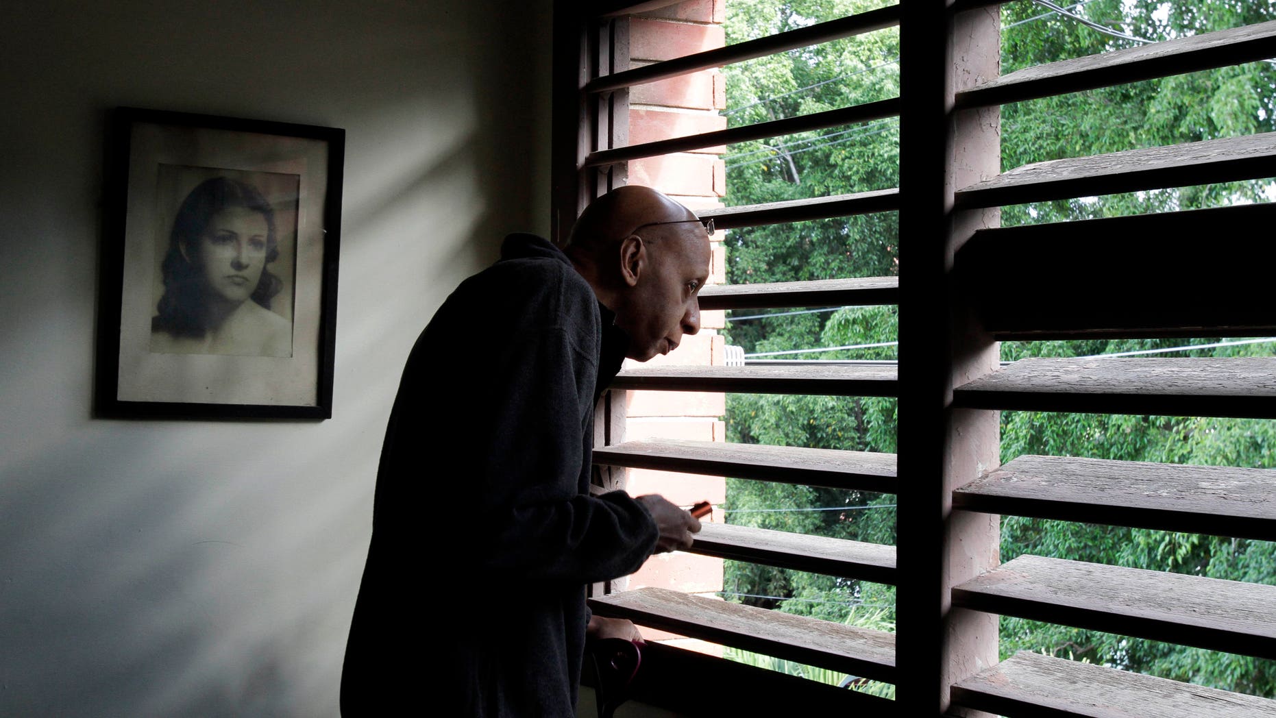 Cuba's dissident Guillermo Farinas looks out a window before a press conference in Havana, Cuba, Tuesday, Dec. 7, 2010. Farinas spent three weeks in the hospital early this year after a 134-day hunger strike to force the government to release opposition leaders jailed since 2003. (AP Photo/Franklin Reyes)