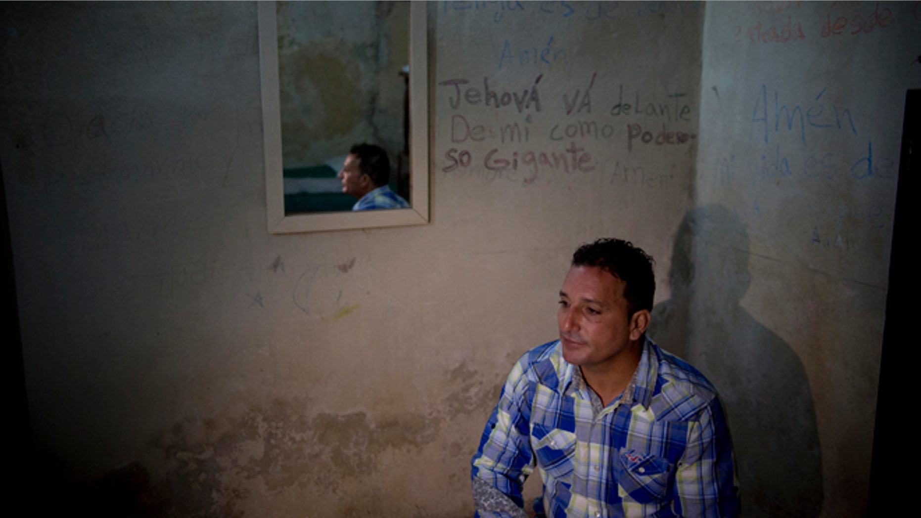 A day after his release, dissident Wilberto Parada, 42, sits for an interview in his home in Havana, Cuba, Friday, Jan. 9, 2015. Advocates, relatives and dissidents say that Cuba has freed at least 38 people on a U.S. list of imprisoned opposition members. U.S. officials said Friday after weeks of virtual silence that those released had been on the list of 53. (AP Photo/Ramon Espinosa)