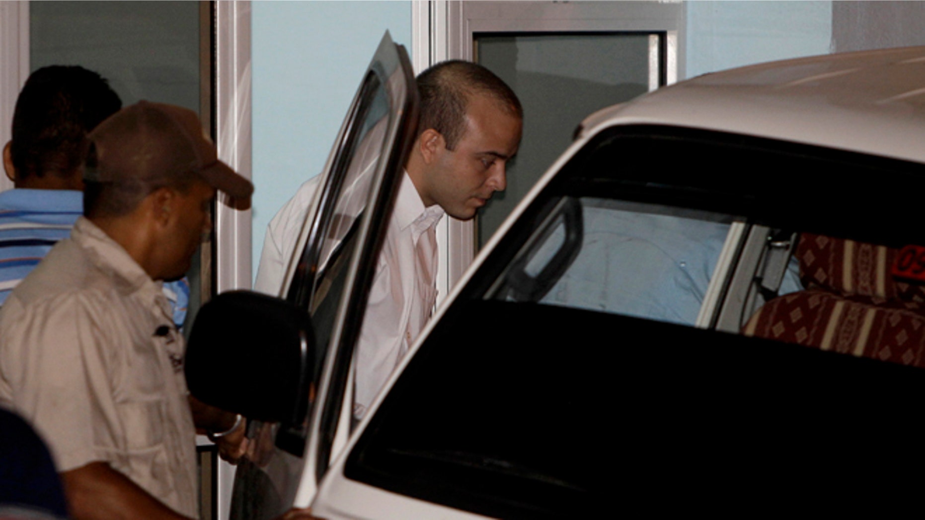 Spanish citizen Angel Carromero, center, enters a vehicle as he leaves the courthouse after his trial in Bayamo, Cuba, Friday, Oct. 5, 2012. Authorities accused Carromero of speeding and charged him with the equivalent of vehicular manslaughter, and prosecutors asked the court for a seven-year sentence. The car crash killed a prominent Cuban dissident Oswaldo Paya and another dissident, Harold Cepero on July 22. A panel of judges will now consider the evidence and issue a ruling at an unspecified future date. (AP Photo/Franklin Reyes)