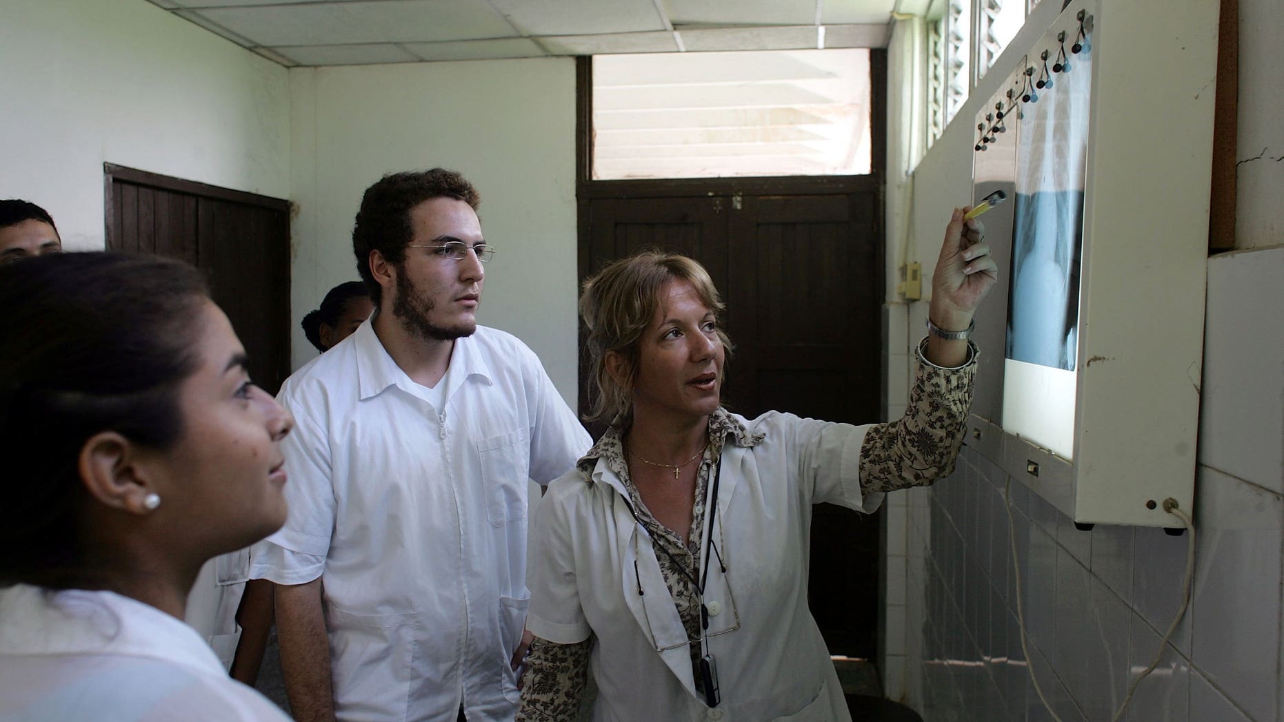 HAVANA - DECEMBER 04: Dr. Nancy Magarita Gonzalez Rodriguez goes over an x-ray with her students at the Latin American School of Medical Sciences December 4, 2006 in Havana, Cuba. Students study at the LASMS campus for the first two years, and then go to another of Cuba's 22 medical schools, which are connected to hospitals and policlinics. The Cuban medical training model combines theory and practice and is oriented toward primary care, community medicine and hands-on internships. LASMS currently has more than 8,000 students enrolled from 24 countries in Latin America, the Caribbean, Africa, and the United States. (Photo by Joe Raedle/Getty Images)