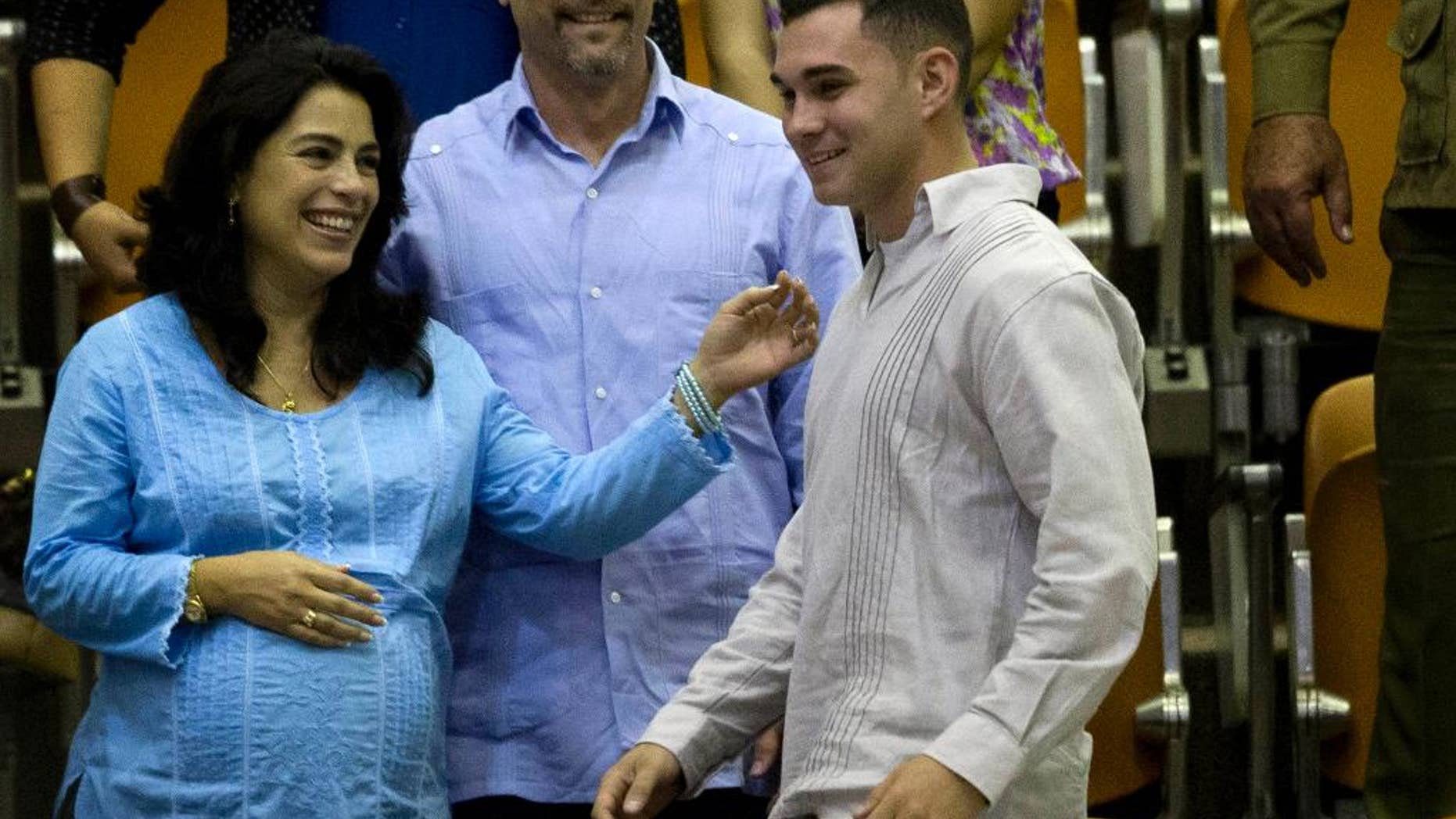 FILE - In this Dec. 20, 2014, file photo, Elian Gonzalez, the young Cuban rafter who was at the center of a bitter custody battle in 2000 between relatives in Miami and his father in Cuba, attends the closing ceremony of the legislative session at the National Assembly in Havana, Cuba. Gonzalez said during an ABC News interview that aired Monday, May 18, 2015, that if he could visit anywhere, it would be the United States so he could “give my love to (the) American people.” (AP Photo/Ramon Espinosa, File)