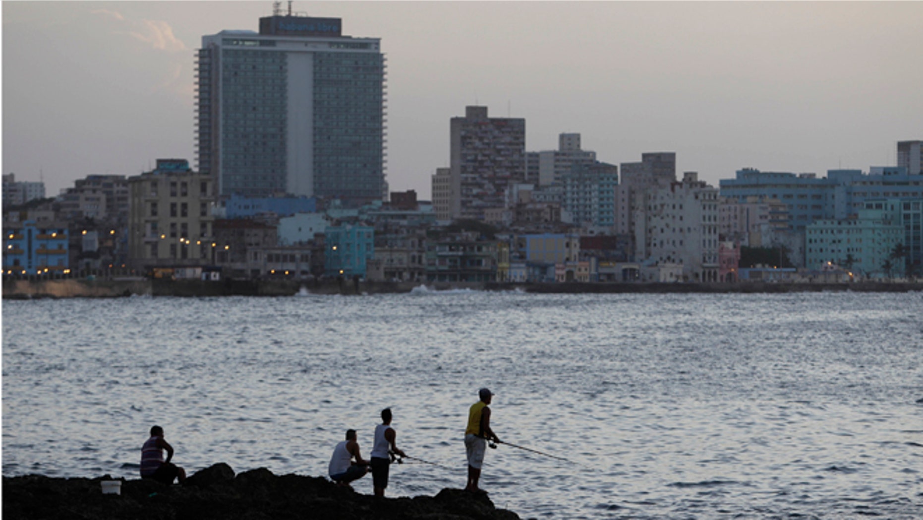 FILE - In this July 8, 2013 file photo, fishermen cast their lines along the Malecon in Havana, Cuba. The number of Cubans heading to the United States has increased dramatically since the island lifted travel restrictions last year, eliminating a costly exit visa and making it easier for emigrants to return to the island, new U.S. government figures show. (AP Photo/Franklin Reyes, File)