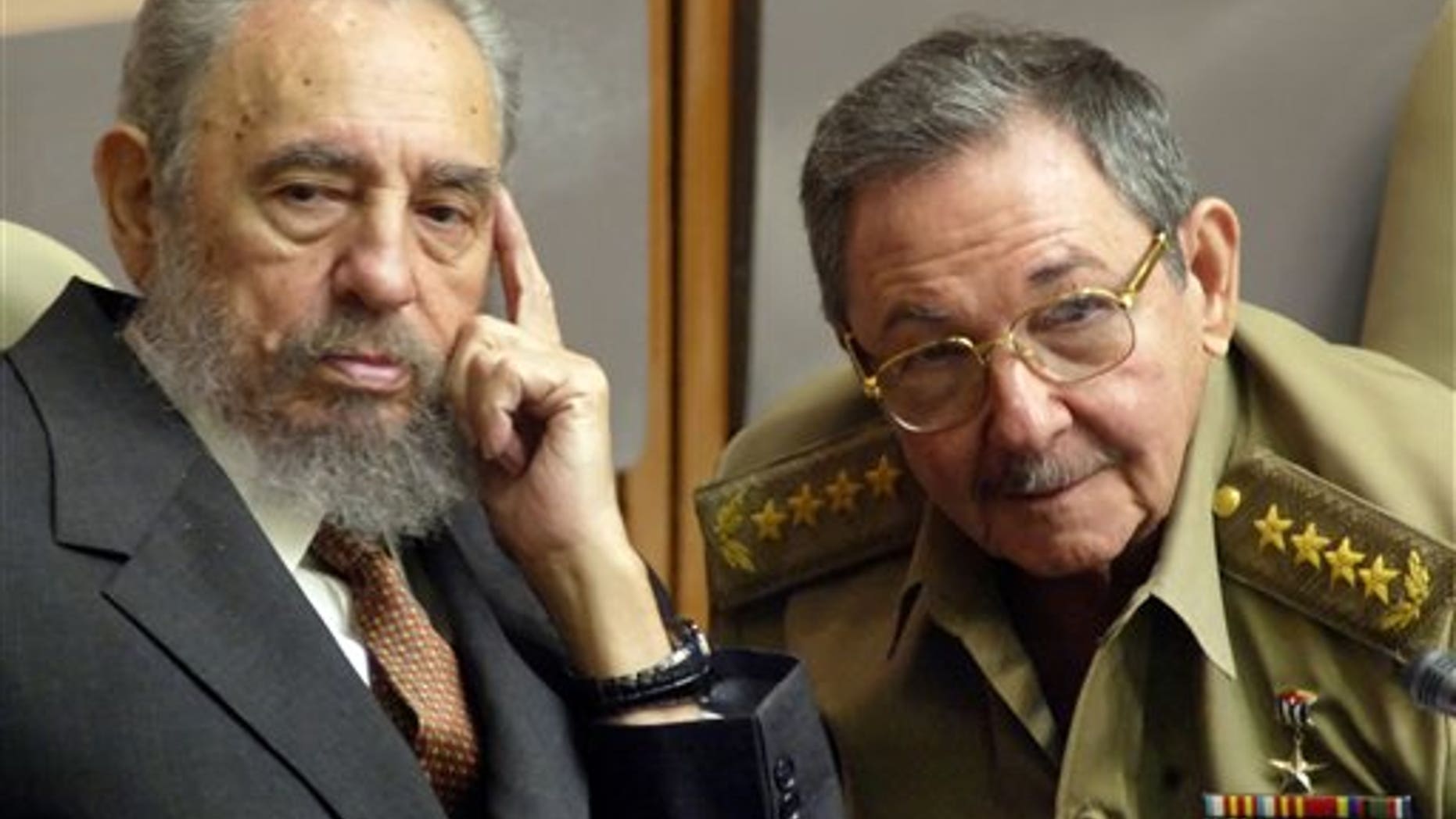 Fidel and Raul Castro, in a 2004 file photo.