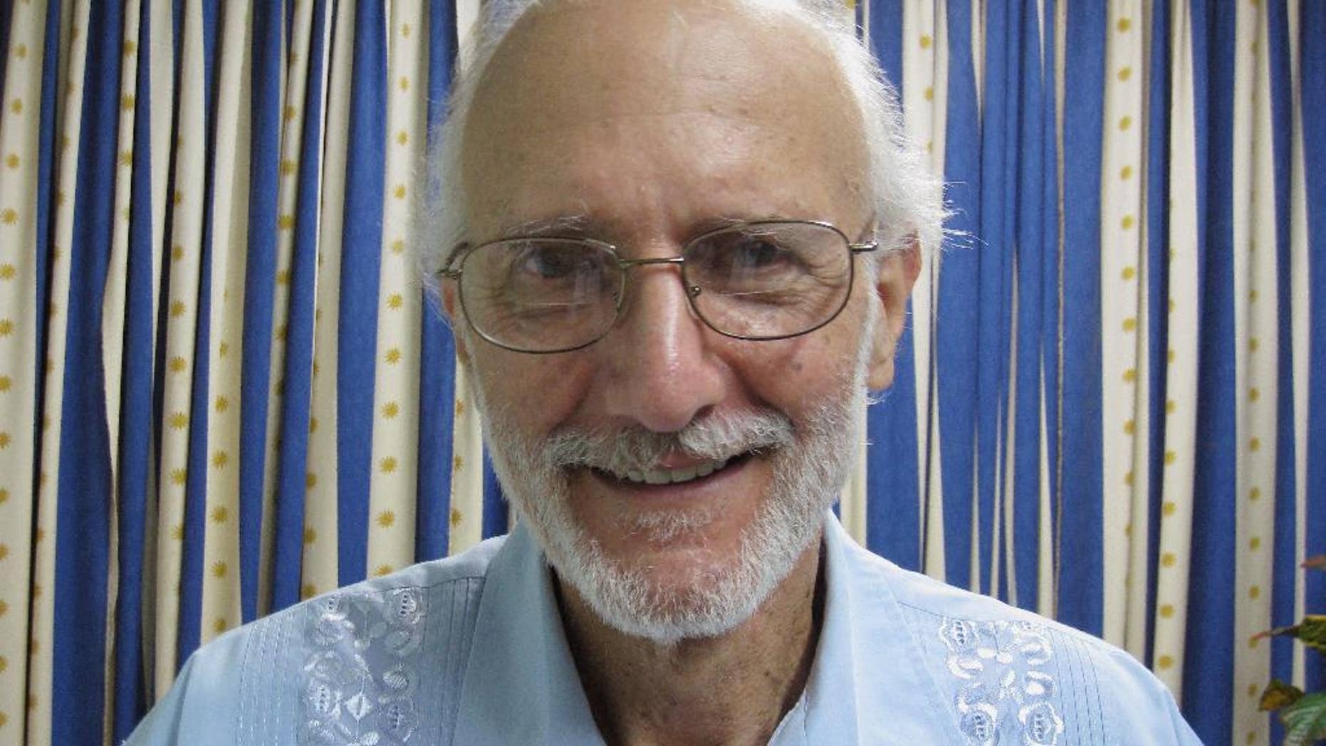 FILE - In this Nov. 27, 2012 file photo provided by U.S. lawyer James L. Berenthal, jailed American Alan Gross poses for a photo during a visit by Rabbi Elie Abadie and Berenthal at Finlay military hospital in Havana, Cuba. Gross, a U.S. government subcontractor imprisoned in Cuba, released a statement through his lawyer Tuesday, April 8, 2014, saying he began fasting to protest his treatment by the governments of Cuba and the United States. (AP Photo/James L. Berenthal, File)