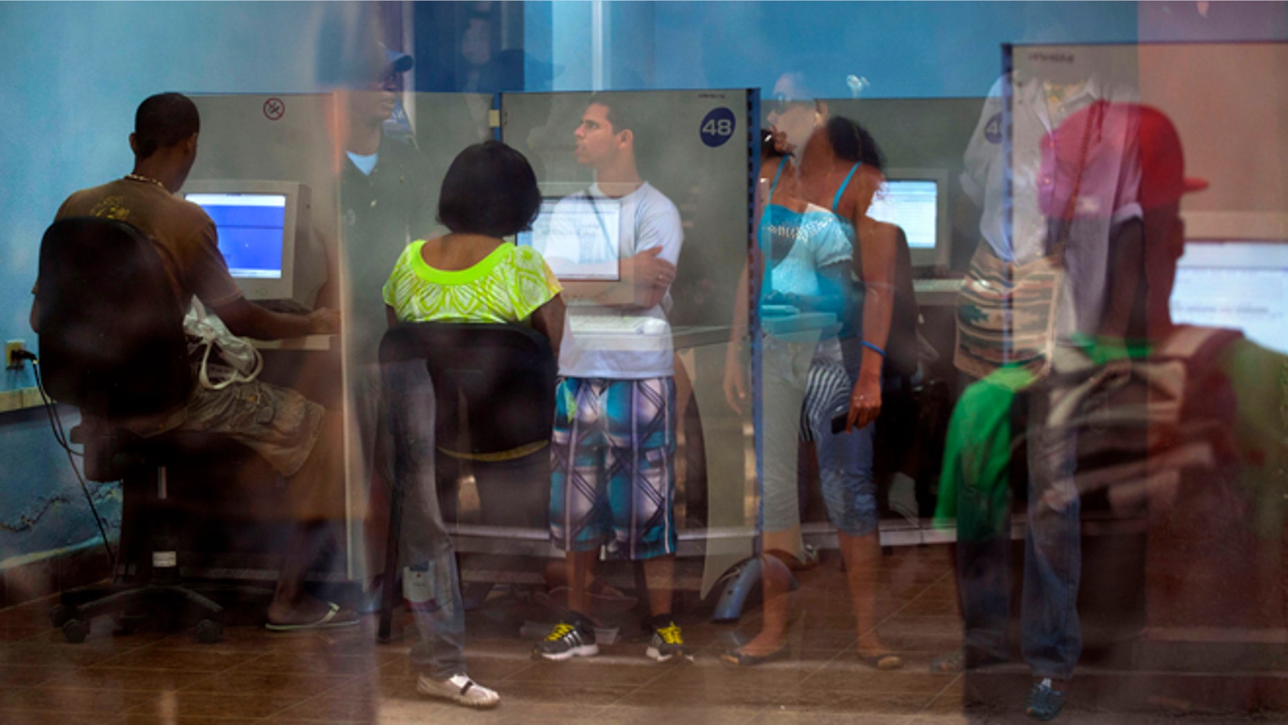 People line up at a post office as they wait to use the Internet service in Havana, Cuba, Tuesday, May 28, 2013.