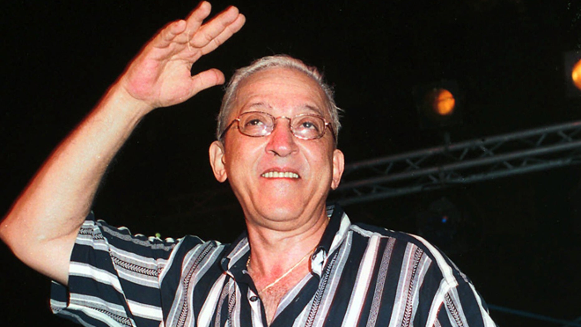 FILE - In this Aug. 26, 2001 file photo, Juan Formell, leader of the Cuban orchestra Los Van Van, performs late Sunday in Havana, Cuba during a farewell summer concert. The noted Cuban musican, who for more than four decades was the driving force behind the big band salsa orchestra Los Van Van, has died. He was 71 years old. Formell's death was announced Thursday, May 1, 2014, on Cuban state television. (AP Photo/Ernesto Mastrascusa, File)