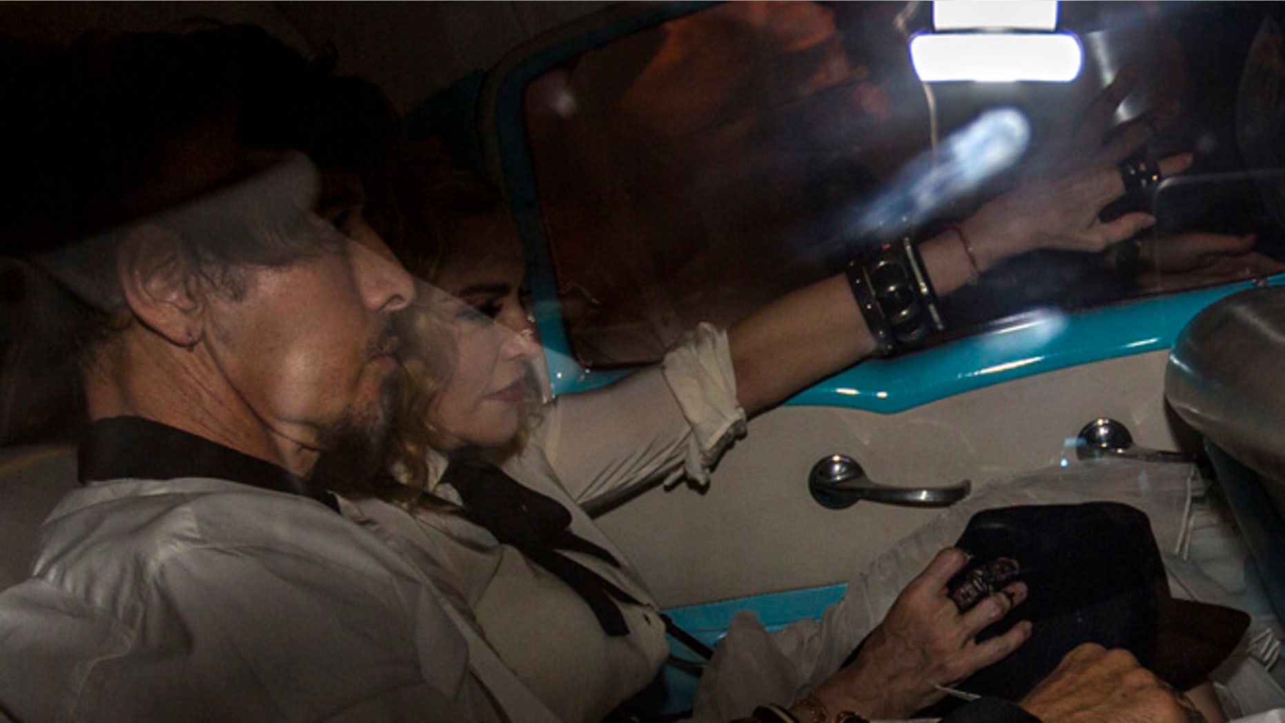 US performer Madonna rides in a classic American car on the way into a landmark private restaurant for a party in Havana, Cuba, Tuesday, Aug. 16, 2016. Madonna is on a private visit to Cuba to celebrate her 58th birthday. (AP Photo/Desmond Boylan)