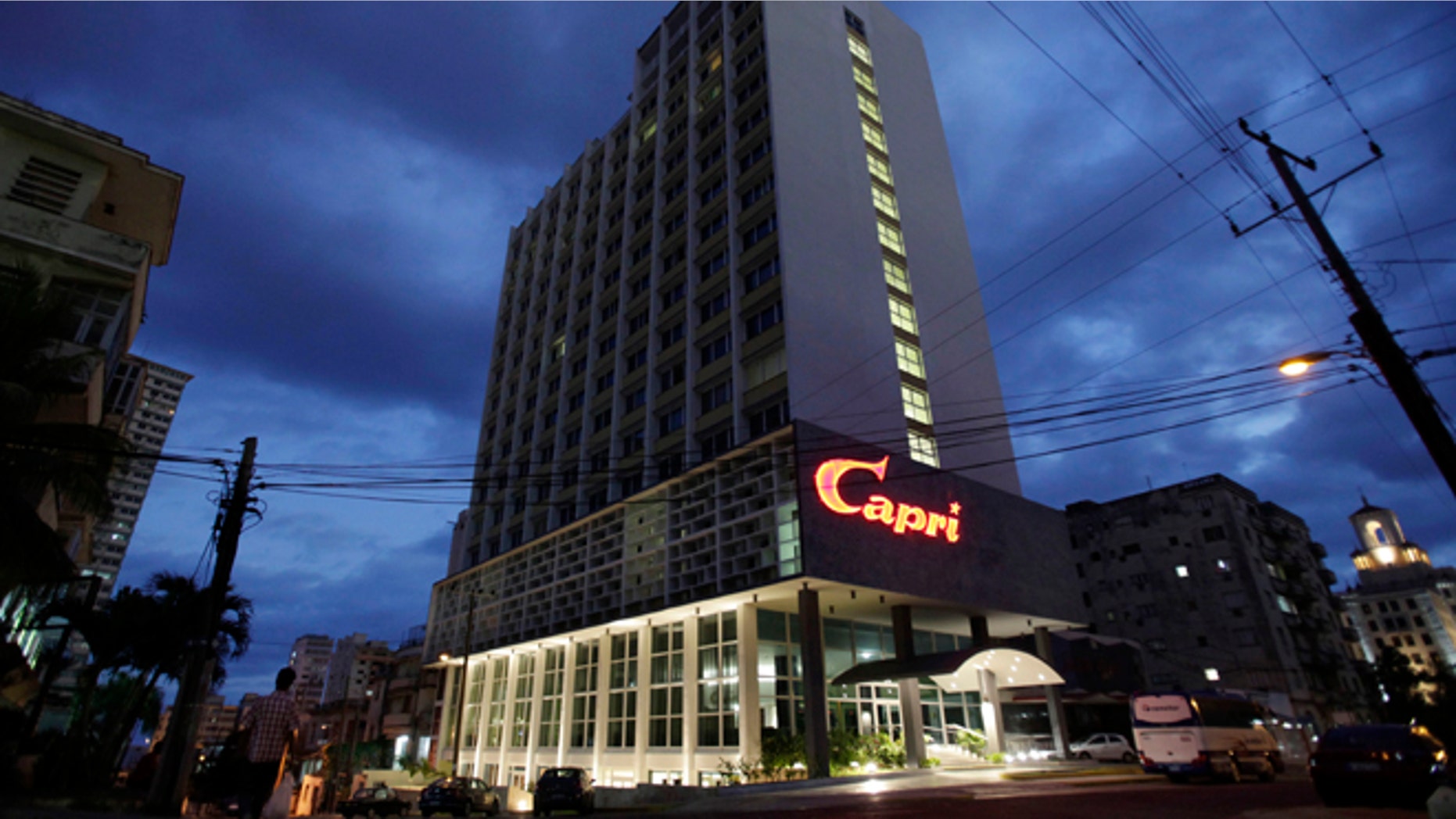 The hotel Capri is illuminated at dawn in Havana, Cuba, Friday, Feb. 14, 2014. Havana's hedonistic mob-and-movie-star days came to an end with Fidel Castro's 1959 revolution, and the hotel drifted into a long, slow decline. But now the Capri is back in business after being closed more than a decade ago. Its rebirth is part of Cuba's latest bid to trade on its colorful pre-Communist past and attract tourist dollars to fund its socialist present. (AP Photo/Franklin Reyes)