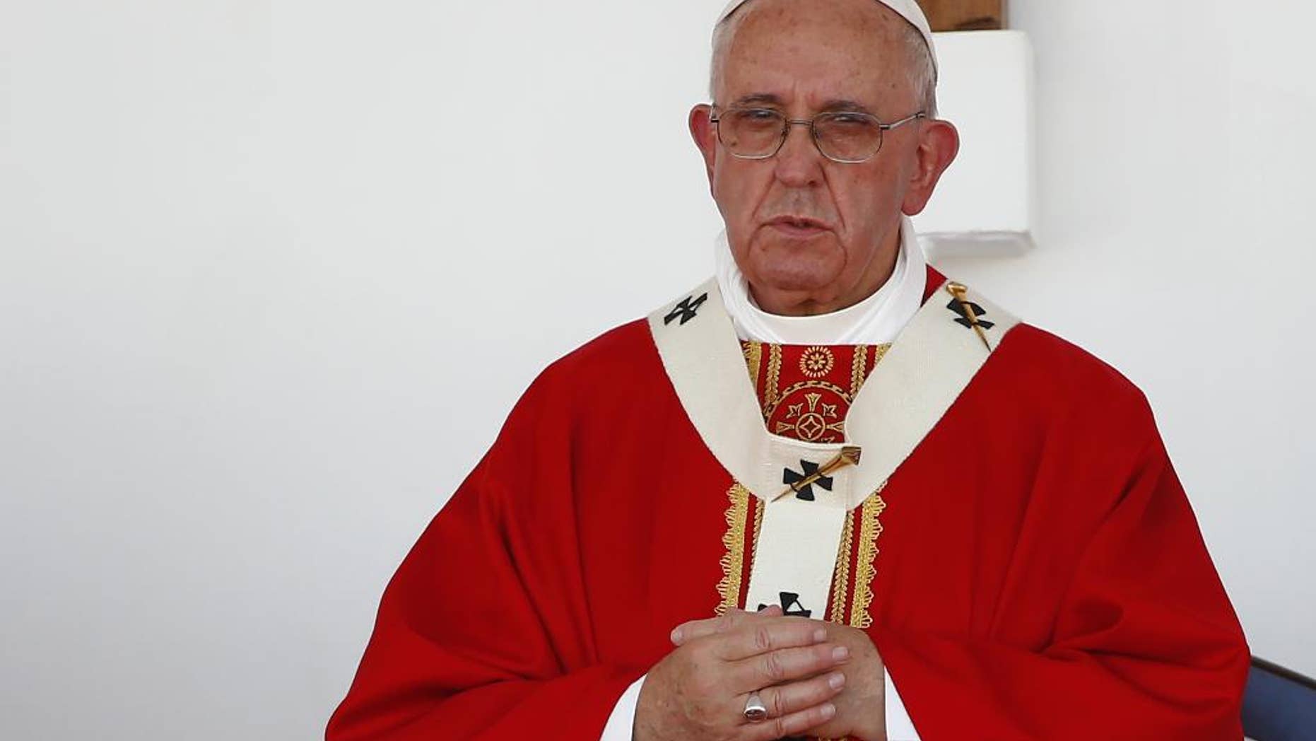 Pope Francis stands on the altar during a Mass in the Plaza of the Revolution, in Holguin, Cuba, Monday, Sept. 21, 2015. Speaking in his homily Francis called on Cubans to heed Jesus Christ's invitation to overcome resistance to change. (Tony Gentile/Pool via AP)