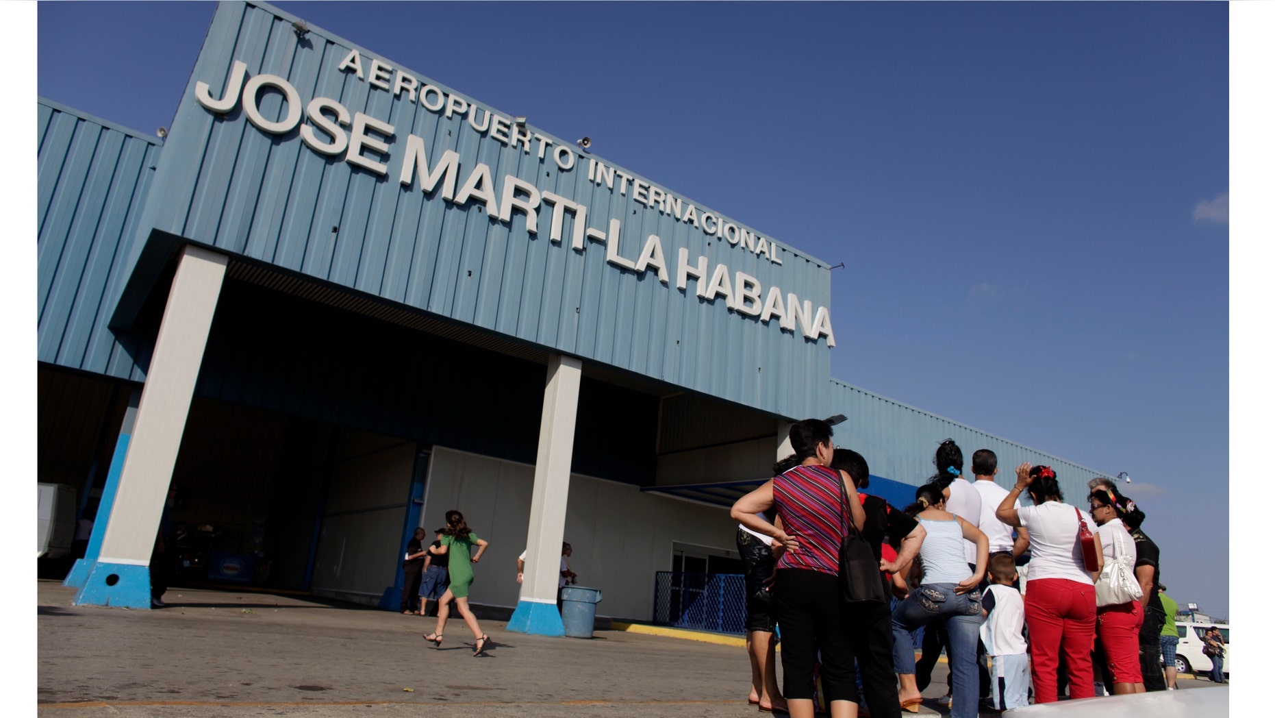 People wait for relatives arriving from the U.S. outside the Jose Marti International Airport in Havana, Cuba. Cuba's government appears on the verge of a momentous decision that could end a half-century of travel restrictions that make it difficult to leave the Communist-run island, even for vacation.