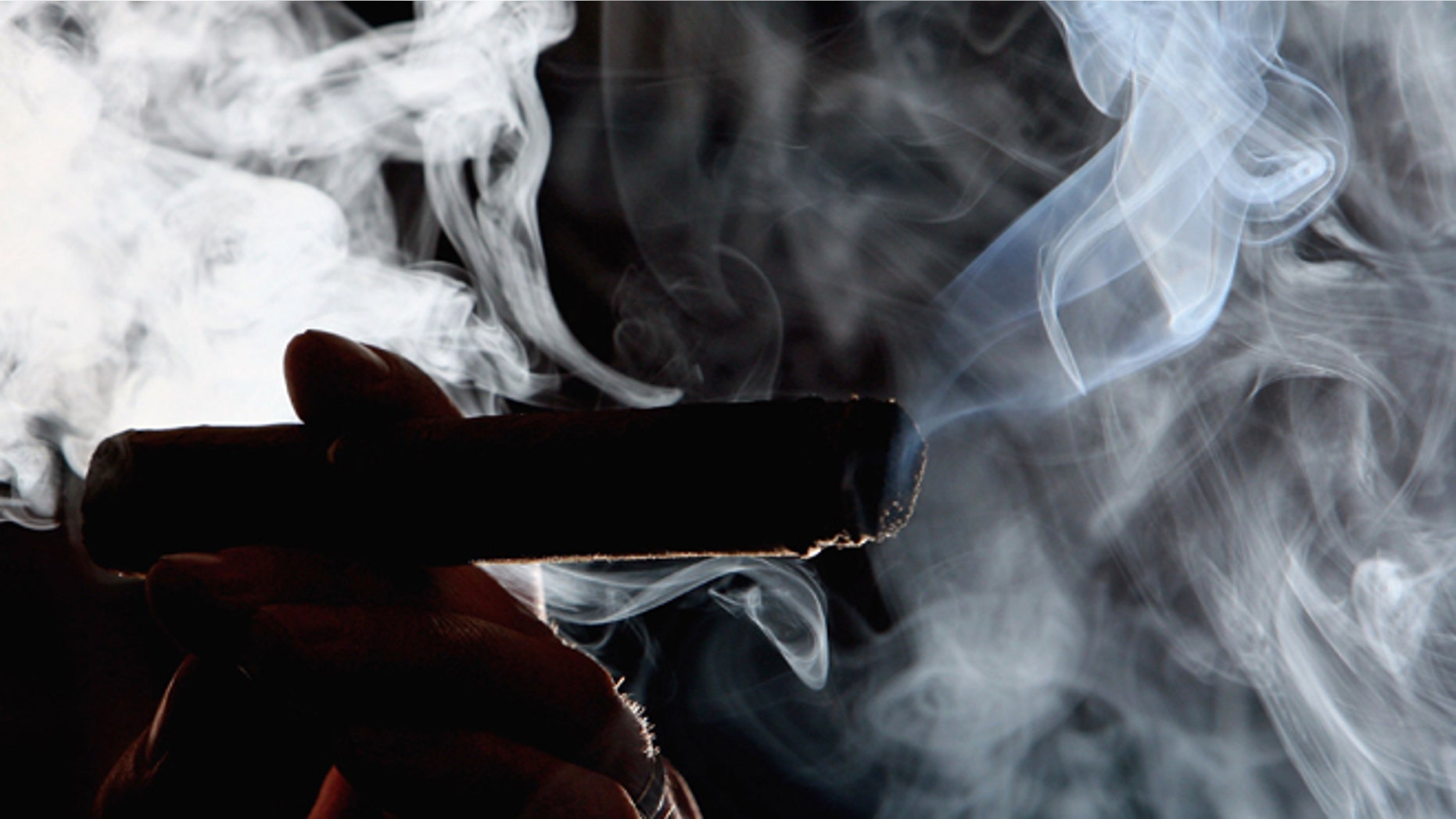 GLASGOW, UNITED KINGDOM - MARCH 20: A man is seen smoking in a cigar shop March 20, 2006, in Glasgow, Scotland. Smoking in public places in Scotland will be banned from the morning of March 26, 2006. (Photo by Jeff J Mitchell/Getty Images)