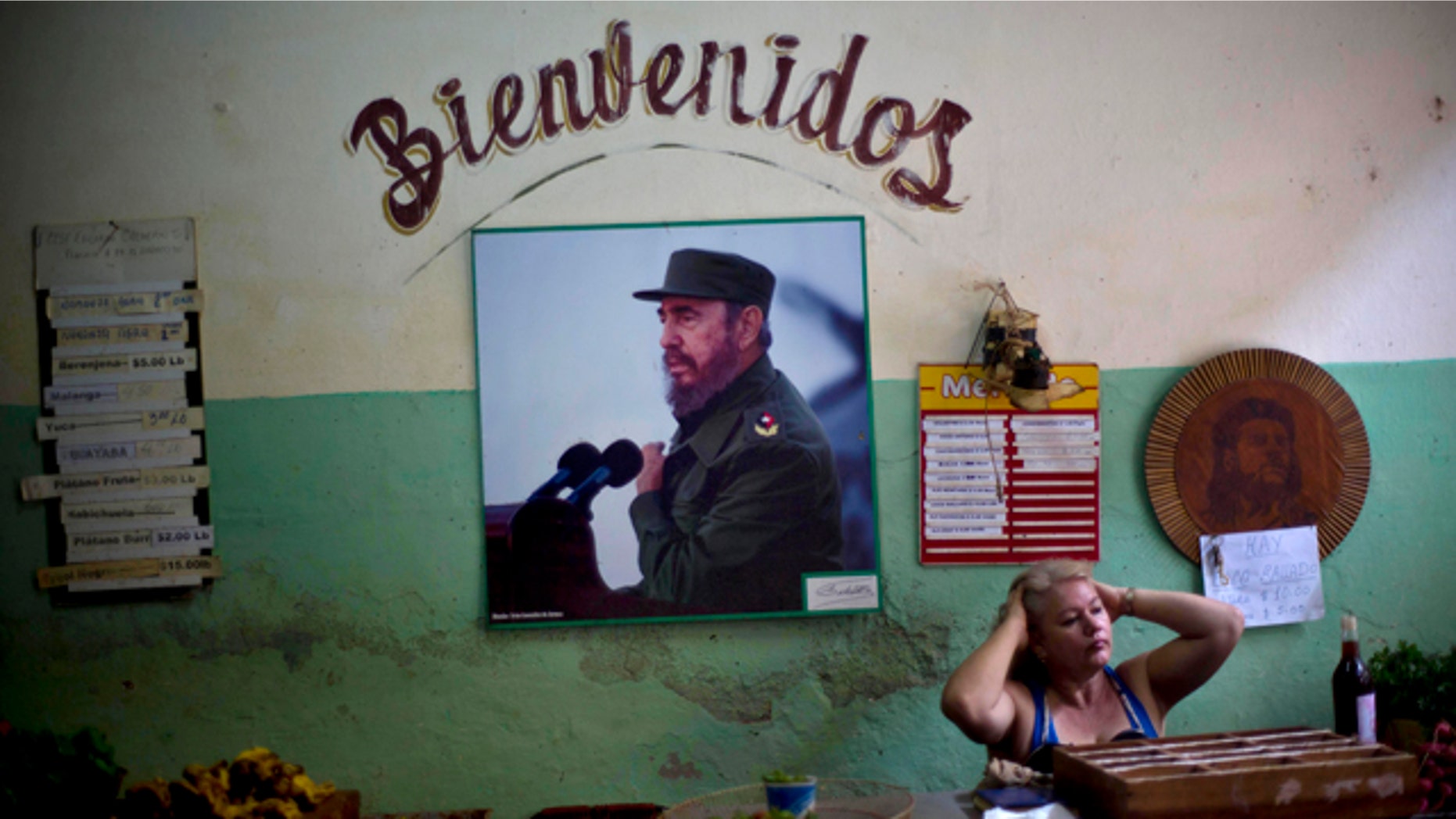 Dec. 26, 2014: A photograph of Fidel Castro hangs under the Spanish word 'Welcome' on the wall at a state-run food market in Havana, Cuba. (AP Photo/Ramon Espinosa, File)