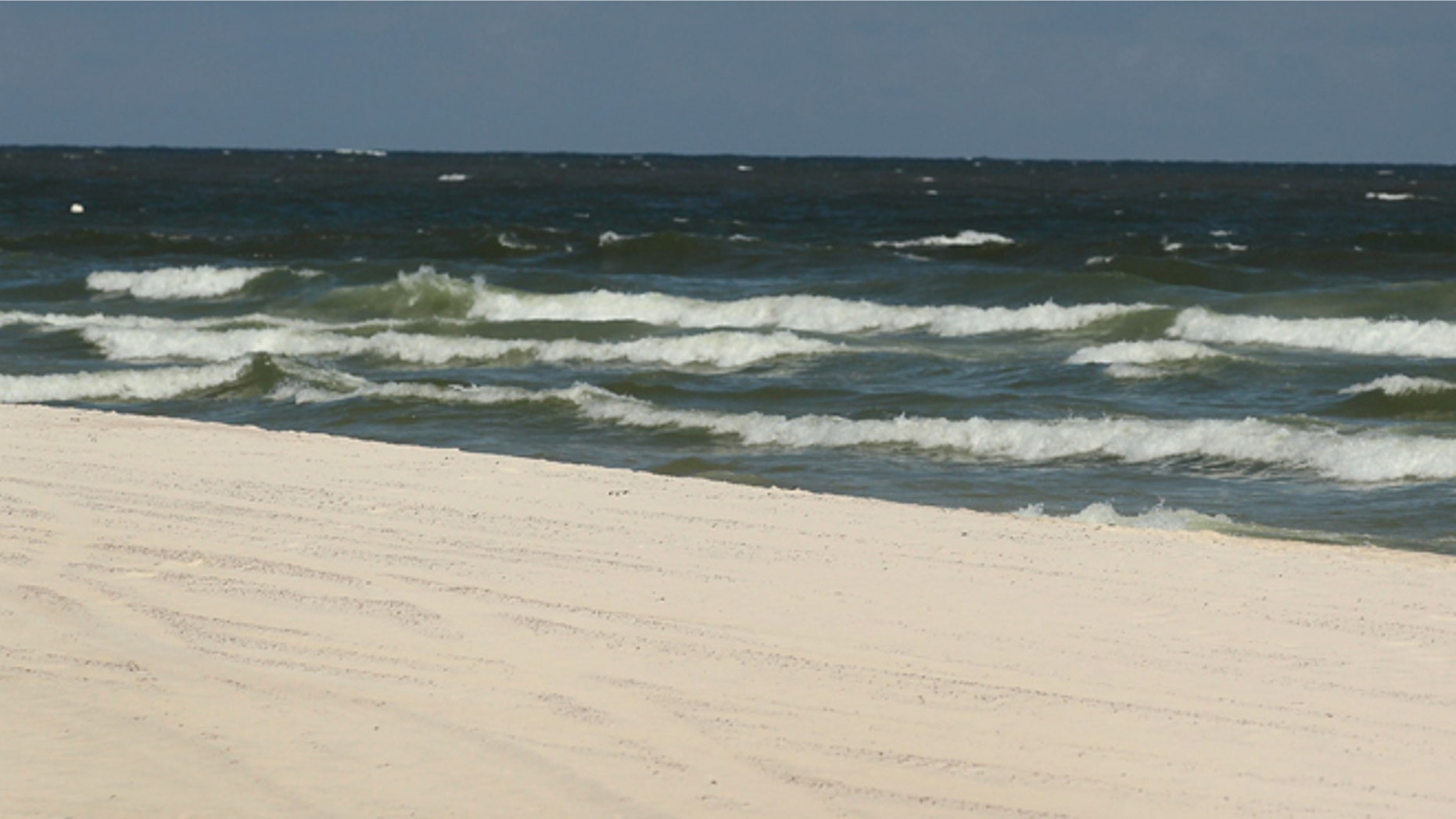 GULF SHORES, AL - JULY 04: Julie Wonder on vacation from Czechoslovakia enjoys an empty beach as people stayed away due to the threat of contamination from the Deepwater Horizon oil spill in the Gulf of Mexico on July 4, 2010 in Gulf Shores,Alabama. The oil spill may have a huge negative economic impact on gulf coast businesses during what should be a busy 4th of July. Millions of gallons of oil have spilled into the Gulf since the April 20 explosion on the drilling platform. (Photo by Joe Raedle/Getty Images) *** Local Caption *** Julie Wonder