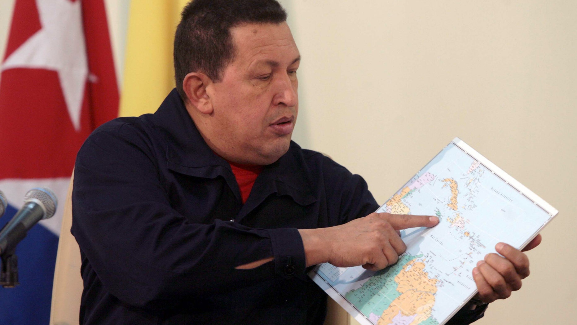 In this photo released by Miraflores Press Office, Venezuela's President Hugo Chavez, left, points at a map of the Caribbean region during a live broadcast interview on Cuban Television, in Havana, Cuba, Sunday Nov. 7, 2010. Chavez is in Cuba to attend meetings between the two governments in the tenth anniversary of their aid and commercial agreements. (AP Photo/Miraflores Press Office, Francisco Batista)