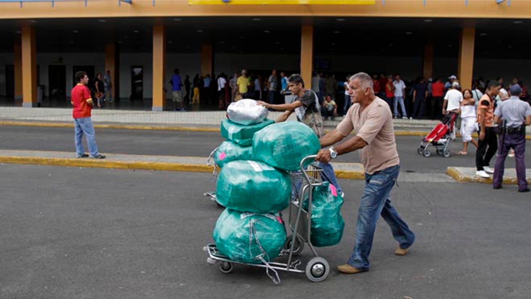 Sept. 3, 2012: Juan, a Cuban-American man who did not want to give his last name, arrives with packages after getting off a flight from the U.S. at the Jose Marti International Airport in Havana.