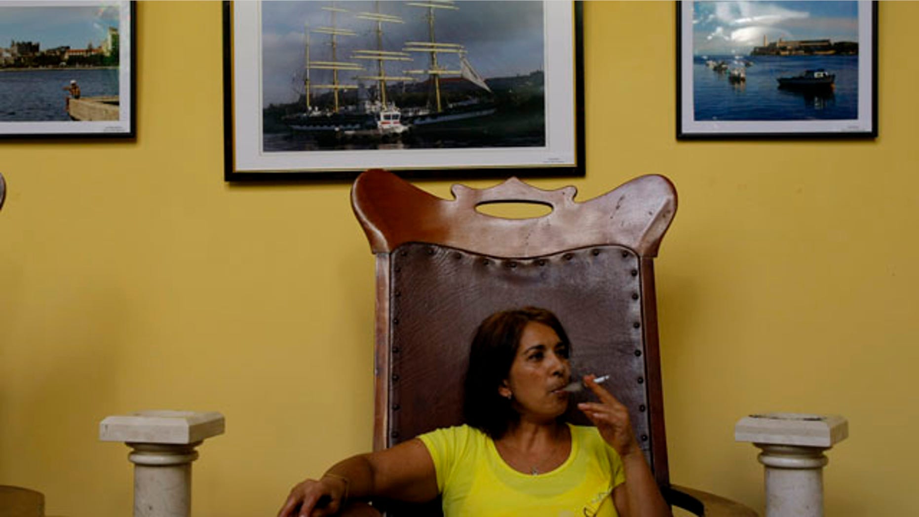 August 25: A woman smokes a cigarette in Havana, Cuba. A program that provided state subsidized smokes to Cuban seniors is going up in smoke. The communist government announced Wednesday it is cutting cigarettes from its monthly ration books effective Sept. 1, the latest step toward keeping potentially risky promises to fully eliminate subsidies on food and other basics which many impoverished islanders depend on. (AP)