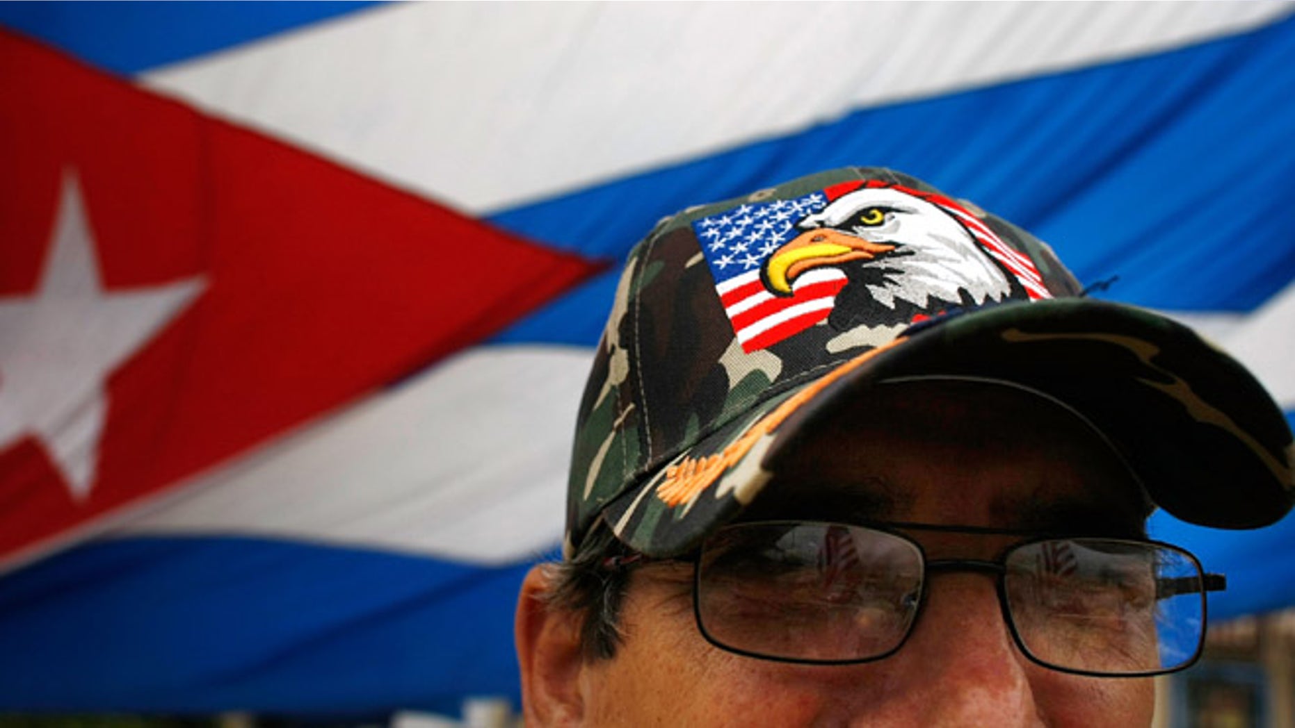 MIAMI - FEBRUARY 19: Ramiro Naval wears an American flag hat as he reacts to the news that Cuban President Fidel Castro announced he will not accept a new term in office in front of the Versailles restaurant in the Little Havana neighborhood February 19, 2008 in Miami, Florida. Castro has announced he is stepping down after 49 years in power, saying he is no longer healthy enough to hold office. (Photo by Joe Raedle/Getty Images)