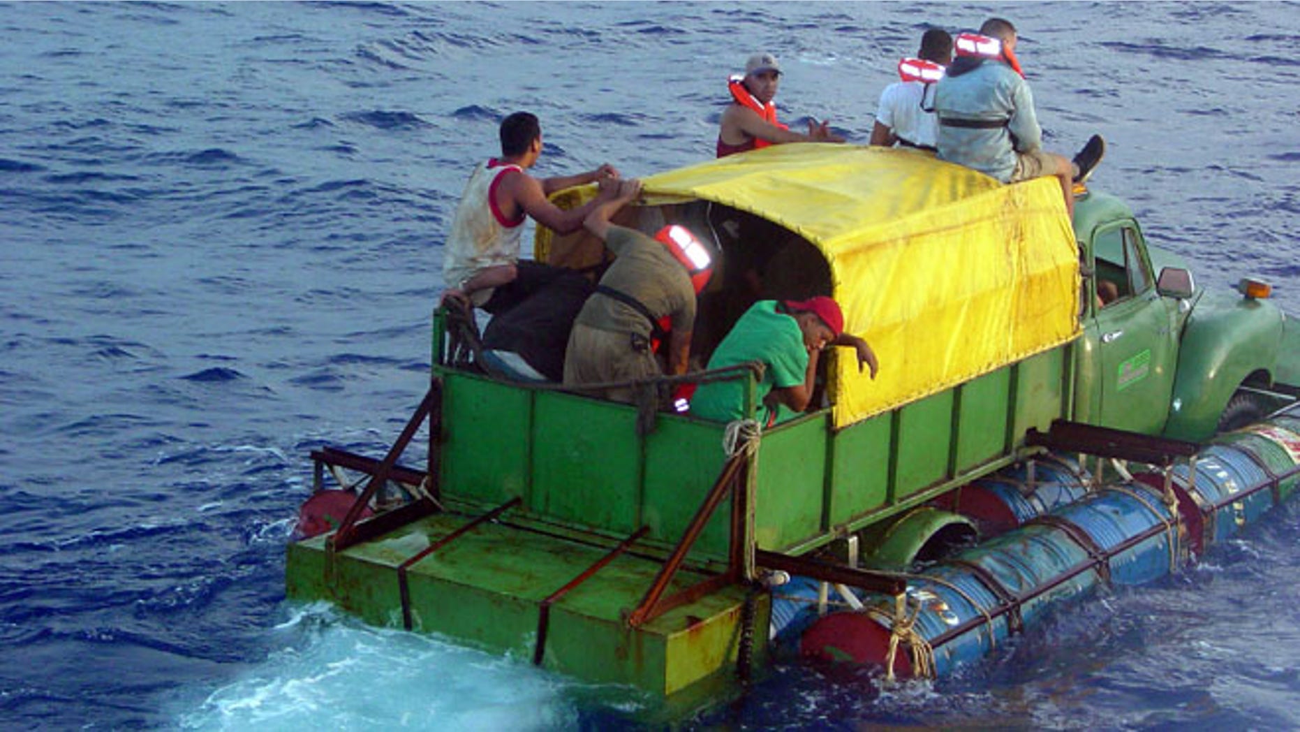 AT SEA - JULY 24: In this U.S. Coast Guard handout, Cuban migrants trying to reach the U.S. coast in Florida ride a makeshift boat made out of a 1951 Chevrolet truck with a propeller driven off the drive shaft July 16, 2003 off the coast of Florida. The U.S. Coast Guard Cutter Key Largo returned the12 Cuban migrants from the vessel back to Cuba after making it within 40 miles of Key West, Florida. The photograph was released a week after the crew was repatriated. (Photo by Gregory Ewald/ U.S. Coast Guard/ Getty Images)
