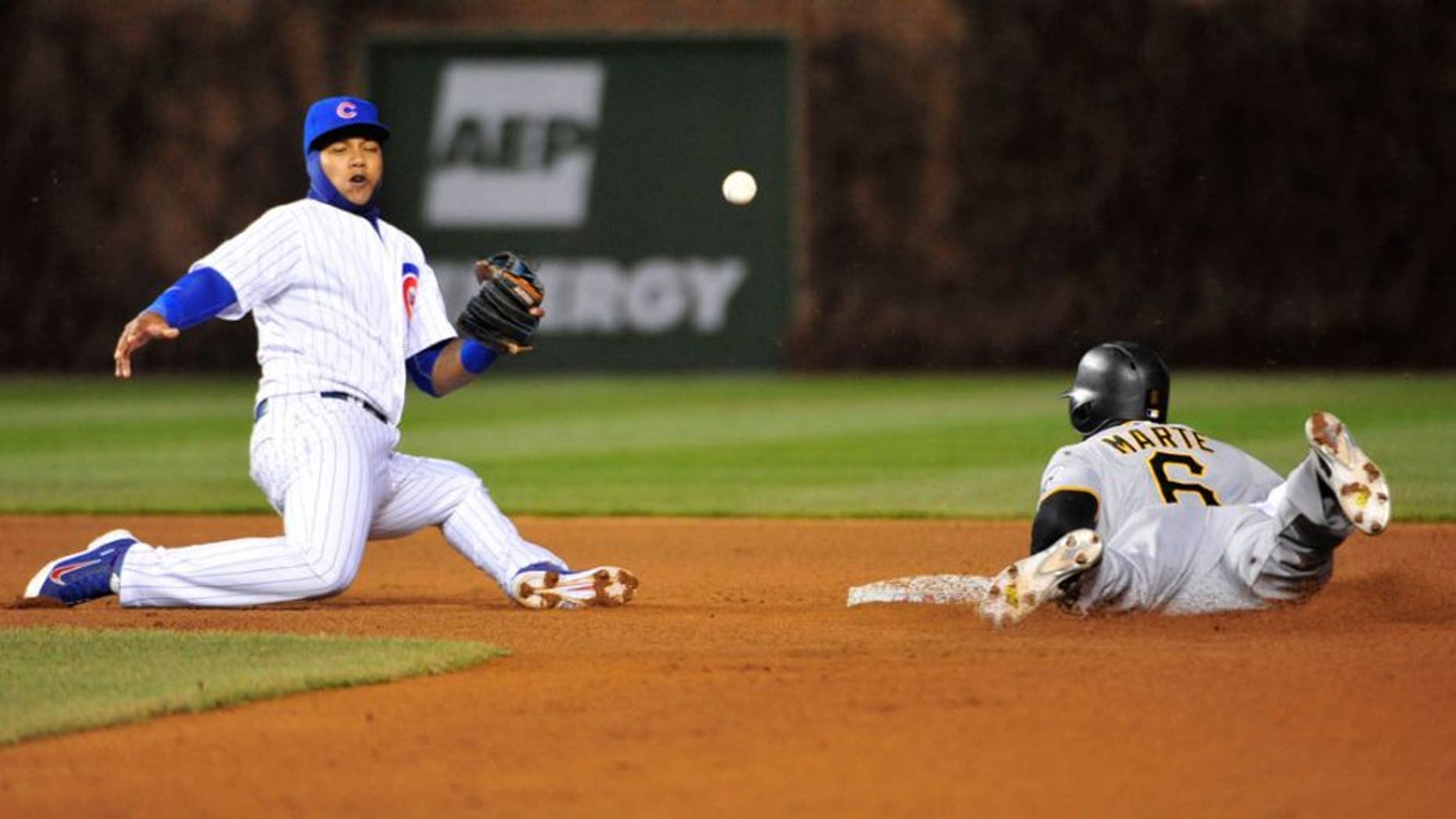CHICAGO, IL - APRIL 29: Starling Marte #6 of the Pittsburgh Pirates steals second base as Starlin Castro #13 of the Chicago Cubs can't handle the throw during the fourth inning on April 29, 2015 at Wrigley Field in Chicago, Illinois. (Photo by David Banks/Getty Images)