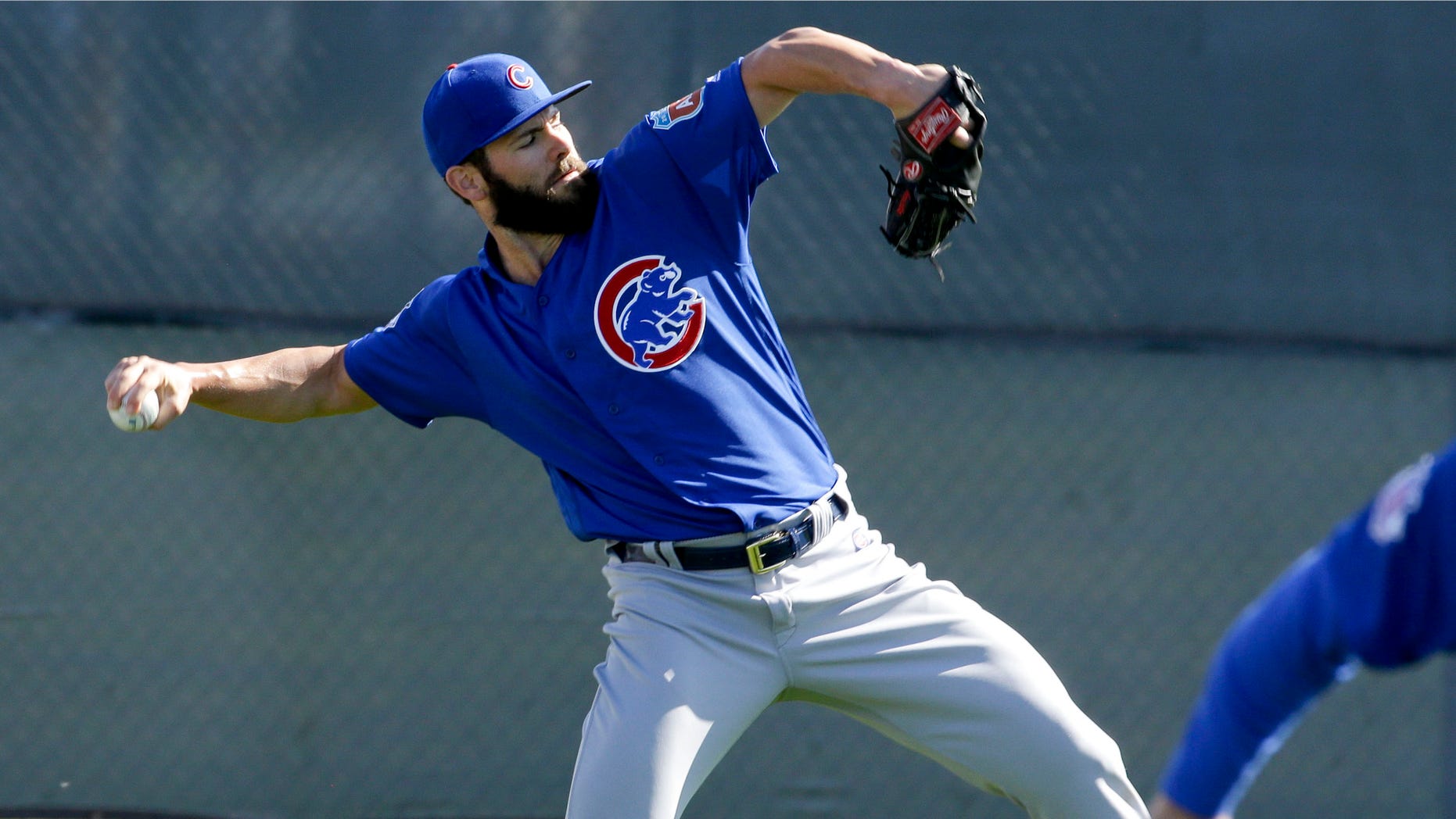 Chicago Cubs starting pitcher Jake Arrieta throws during spring baseball practice in Mesa, Ariz., Saturday, Feb. 20, 2016. (AP Photo/Chris Carlson)