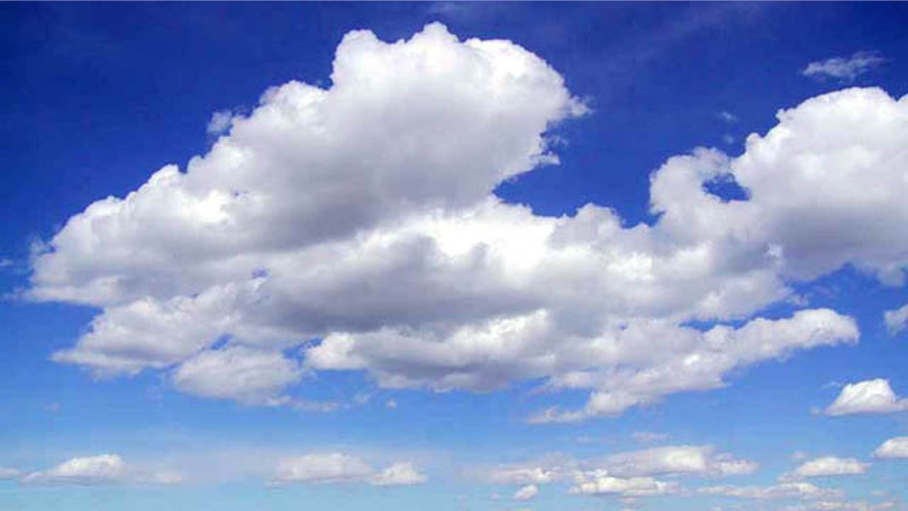 Cumulus clouds swell in a blue sky. What might they be saying to each other?