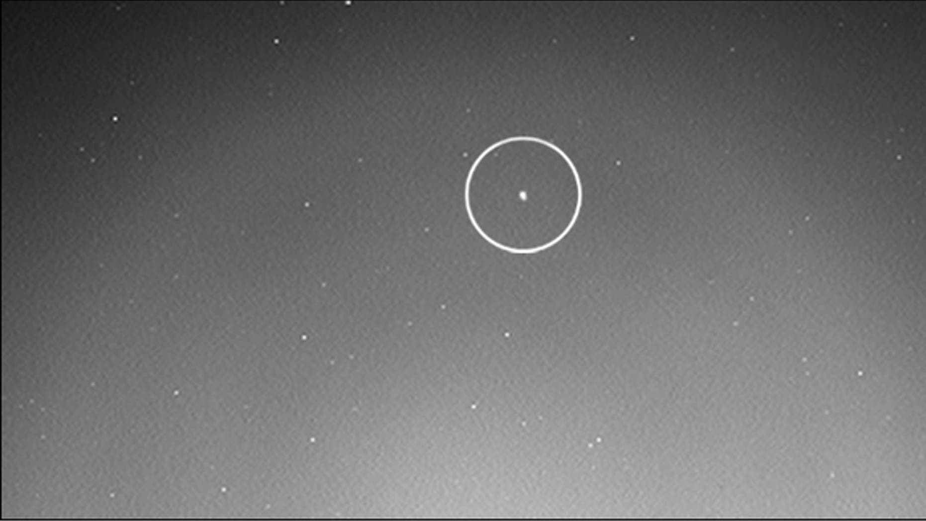 The tiny Mars moon Phobos (circled) rises into the Red Planet sky in this image captured on June 28, 2013 by NASA's Curiosity rover.
