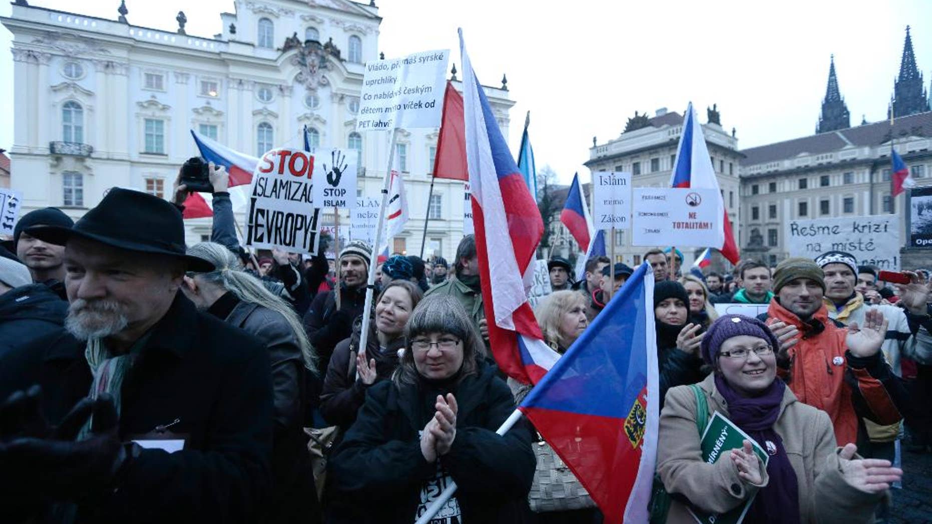 Hundreds of people gather during an anti-Islam rally in Prague, Czech Republic, Friday, Jan. 16, 2015. The gathering came as French and German authorities arrested at least 12 people Friday suspected of links to the Islamic State group and a Paris train station was evacuated, with Europe on alert for new potential terrorist attacks. (AP Photo/Petr David Josek)