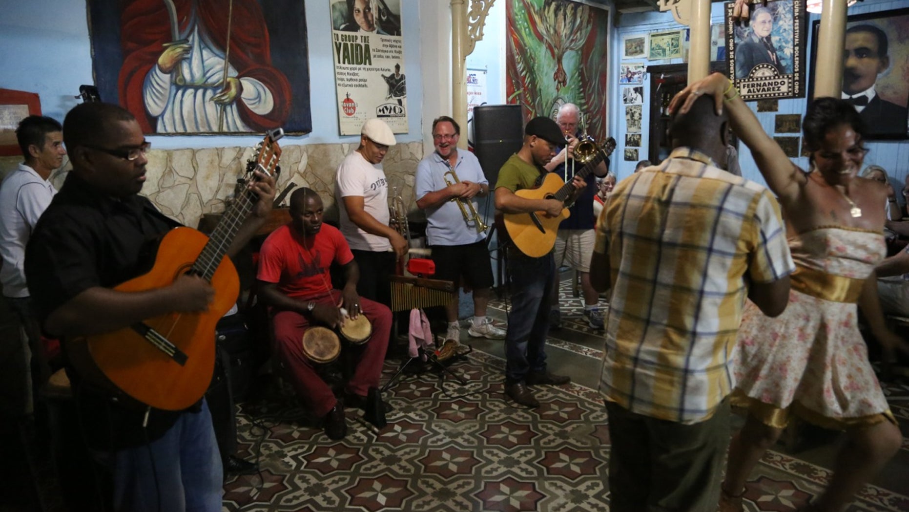 Dr. Mike Davison (light blue shirt) plays his trumpet alongside Cuban musicians at Casa de las Tradiciones, a club in Santiago de Cuba. (Photo by Brian Ross)