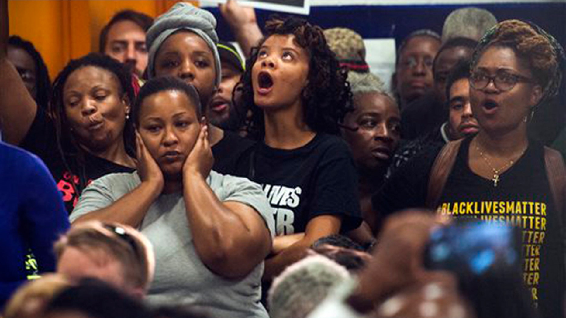 Aug. 27, 2015: People react as Washington D.C. Mayor Muriel Bowser addresses the rise in violent crime in DC during a news conference at the former Malcolm X Elementary School in Congress Heights in Washington, D.C.