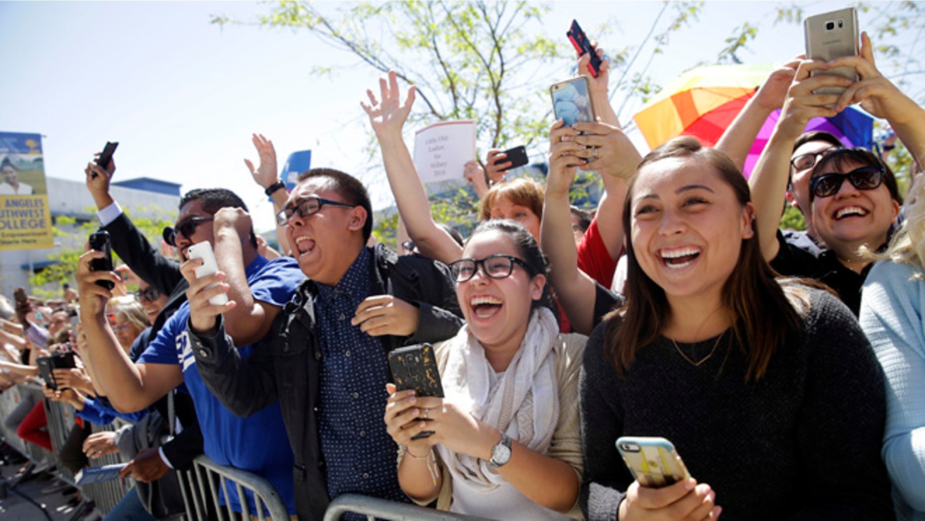 FILE - In this April 16, 2016 file photo, supporters in the overflow area cheer as Democratic presidential candidate Hillary Clinton walks toward them during a campaign event at Los Angeles Southwest College in Los Angeles. Facing a close contest in California with Bernie Sanders, Clinton returns to a crucial battleground this week when she will rally supporters in East Los Angeles, a heavily Hispanic neighborhood which she carried as a presidential candidate in 2008. (AP Photo/Jae C. Hong, File)