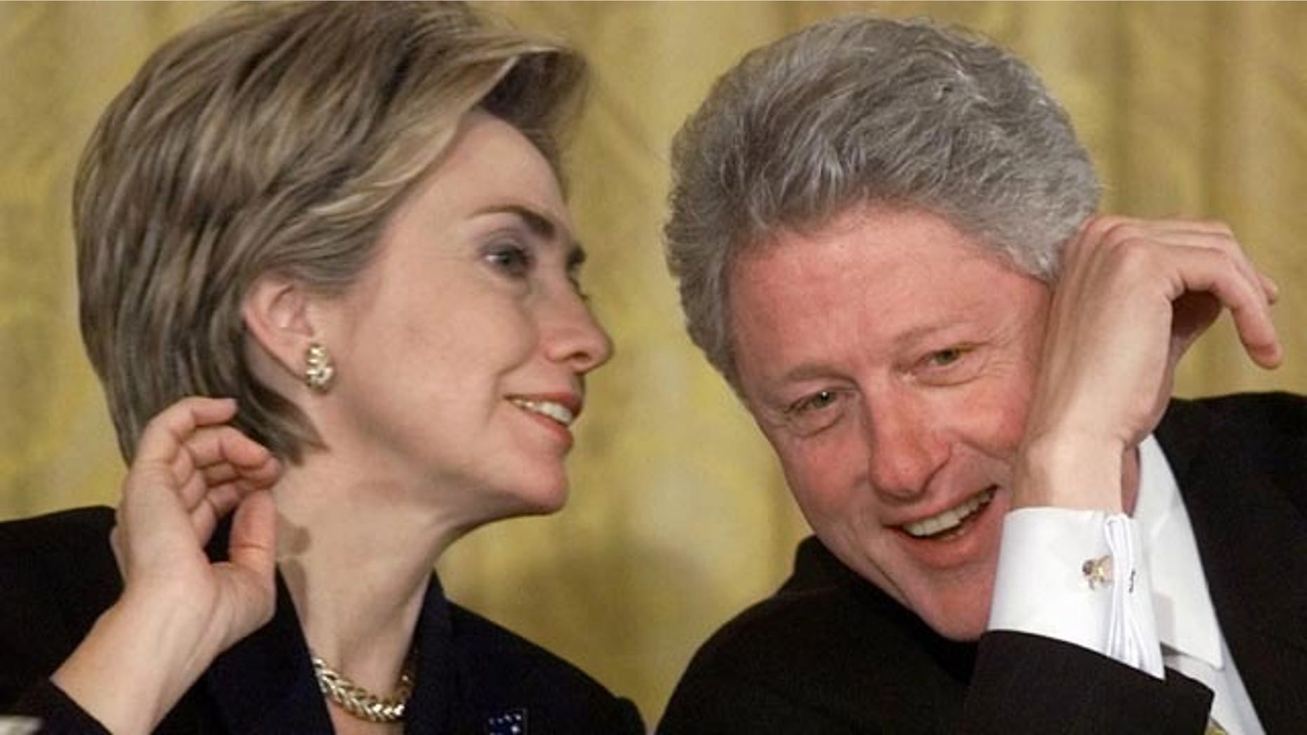 FILE - In this Oct. 22, 1999 file photo, President Bill Clinton and first lady Hillary Rodham Clinton talk during the White House Conference on Philanthropy in the East Room of the White House in Washington. As first lady in the final year of the Clinton administration, Hillary Rodham Clinton approved the unveiling of a White House plan to push for tax breaks for private foundations and wealthy charity donors at the same time that the William J. Clinton Foundation was soliciting donations for her husbands presidential library, recently-released Clinton-era documents show. (AP Photo/Khue Bui, File)