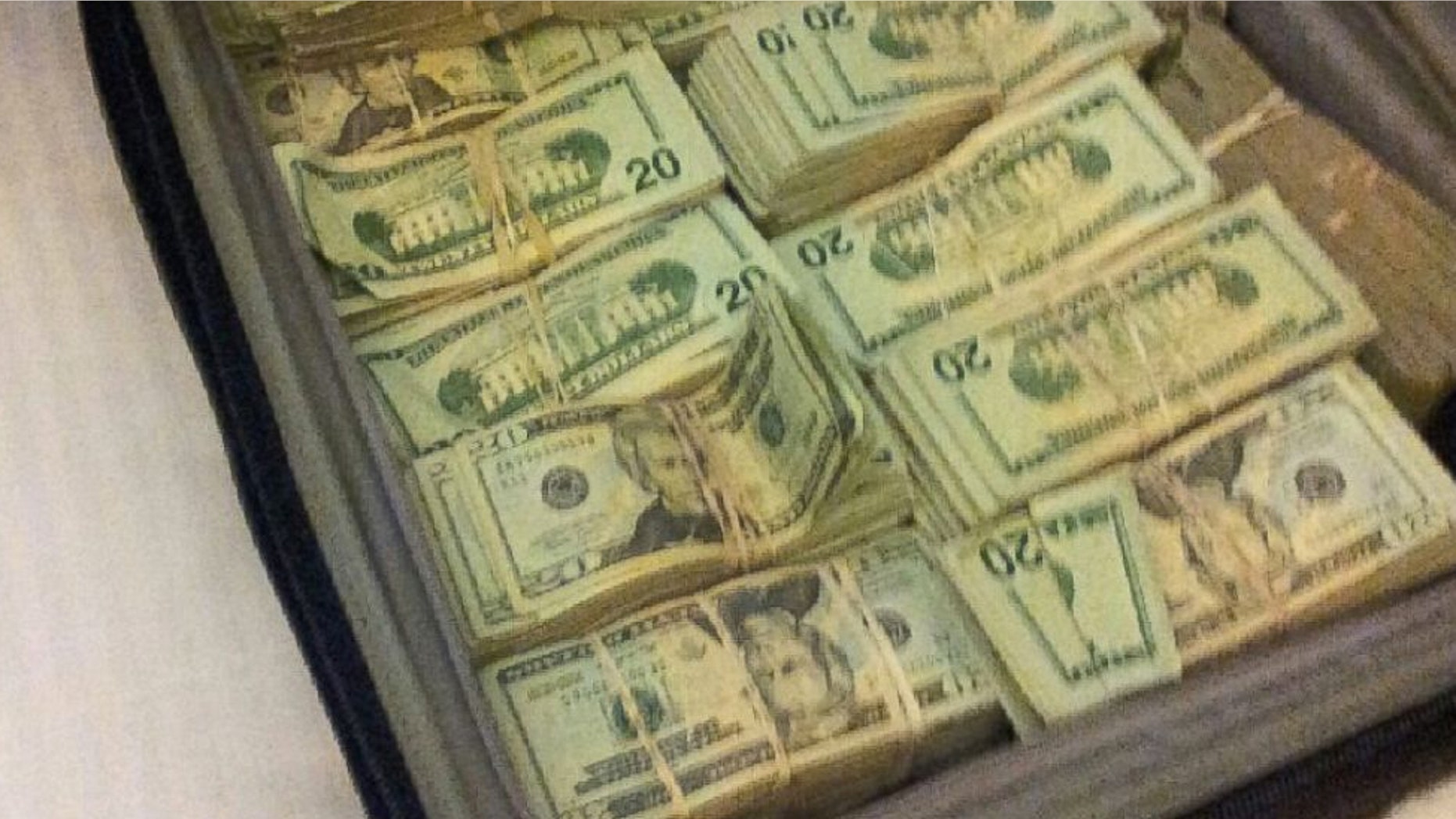 A satchel of money officials allege was found on the defendants when they were arrested. (Department of Justice)