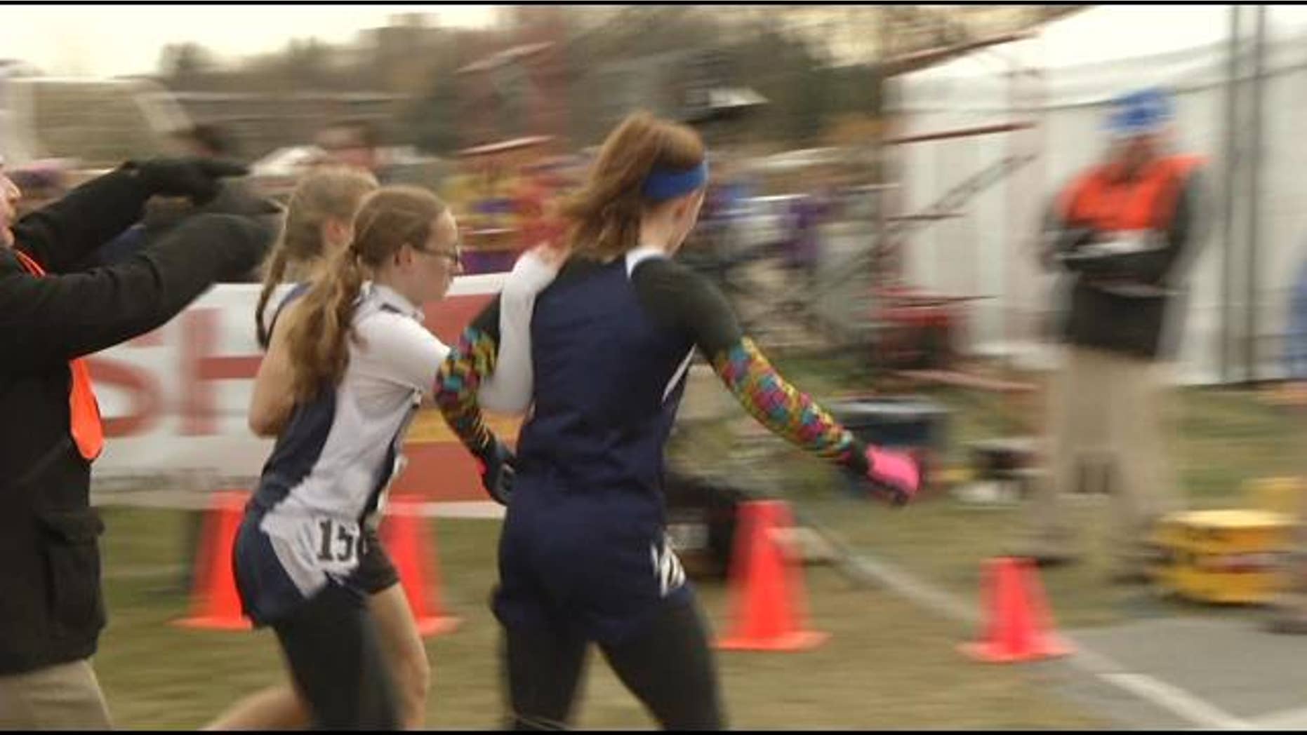 Senior Kailee Kiminski, of Esko, and junior Tierney Winter, of Janesville, forfeited the race last weekend after assisting Jackson County Central freshman Jessica Christoffer cross the finish line. (Courtesy: KEYC-TV)