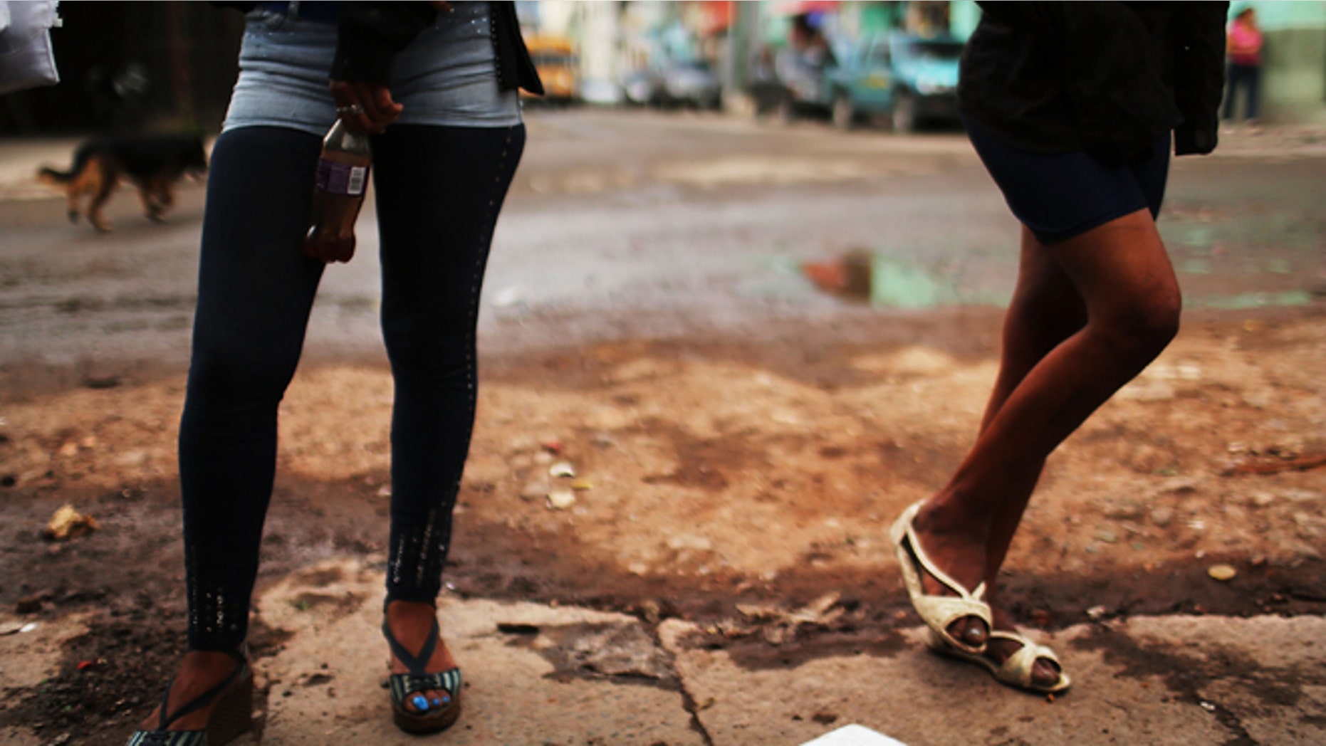 TEGUCIGALPA, HONDURAS - JULY 18: Sex workers wait for customers in a gang infested neighborhood on July 18, 2012 in Tegucigalpa, Honduras. Honduras now has the highest per capita murder rate in the world and its capital city, Tegucigalpa, is plagued by violence, poverty, homelessness and sexual assaults. With an estimated 80% of the cocaine entering the United States now being trans-shipped through Honduras, the violence on the streets is a spillover from the ramped rise in narco-trafficking. The non-governmental organization Doctors Without Borders has set up a program in the capital that looks to provide medical and psychological care to the homeless population. Each day a team goes out into the streets to meet with vulnerable groups of homeless to assess their needs. (Photo by Spencer Platt/Getty Images)
