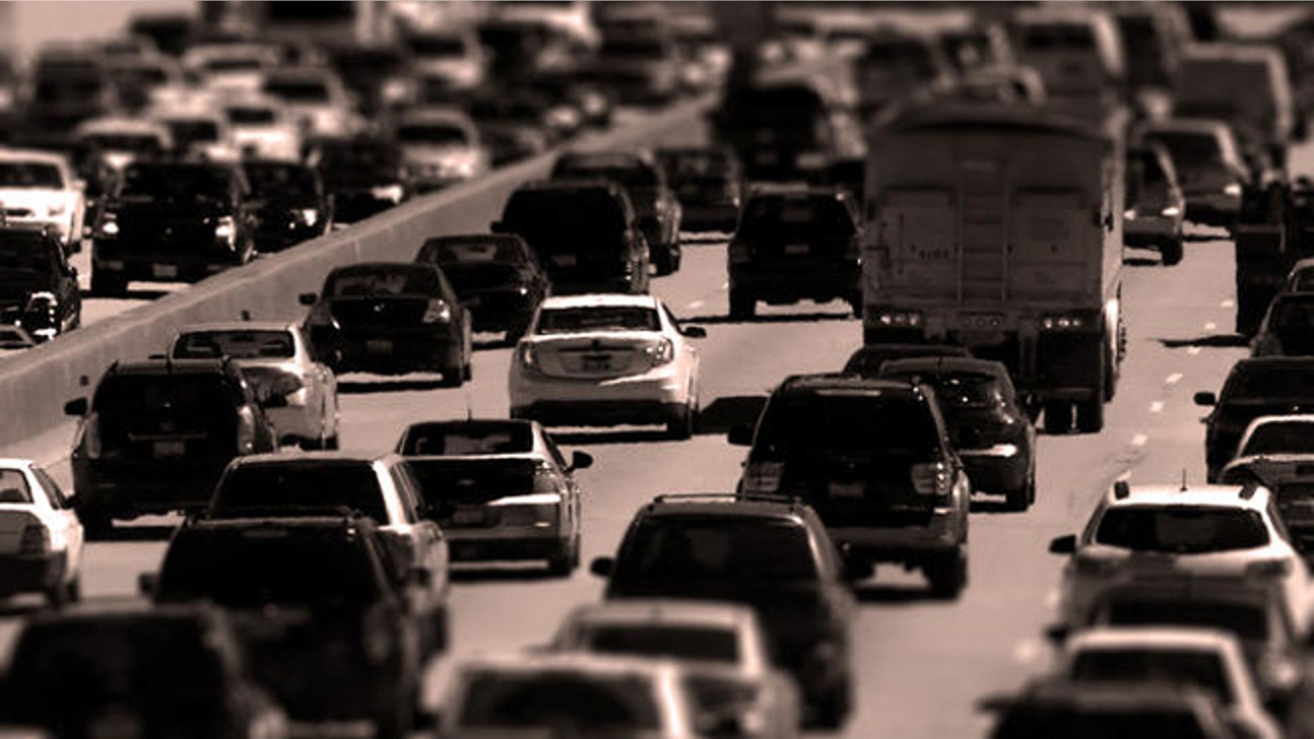 Traffic begins to thicken as motorists getting an early jump to Memorial Day destinations in Indiana and Michigan travel an interstate freeway through Chicago Friday, May 24, 2013. (AP Photo/Charles Rex Arbogast)