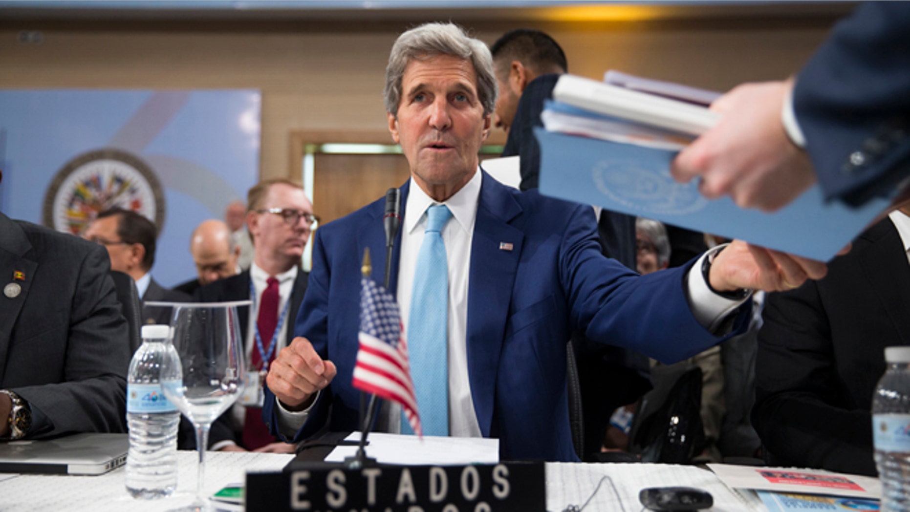 Secretary of State John Kerry is handed notes as he sits down for the General Assembly of the Organization of American States, Tuesday, June 14, 2016, in Santo Domingo, Dominican Republic. (AP Photo/Evan Vucci, Pool)