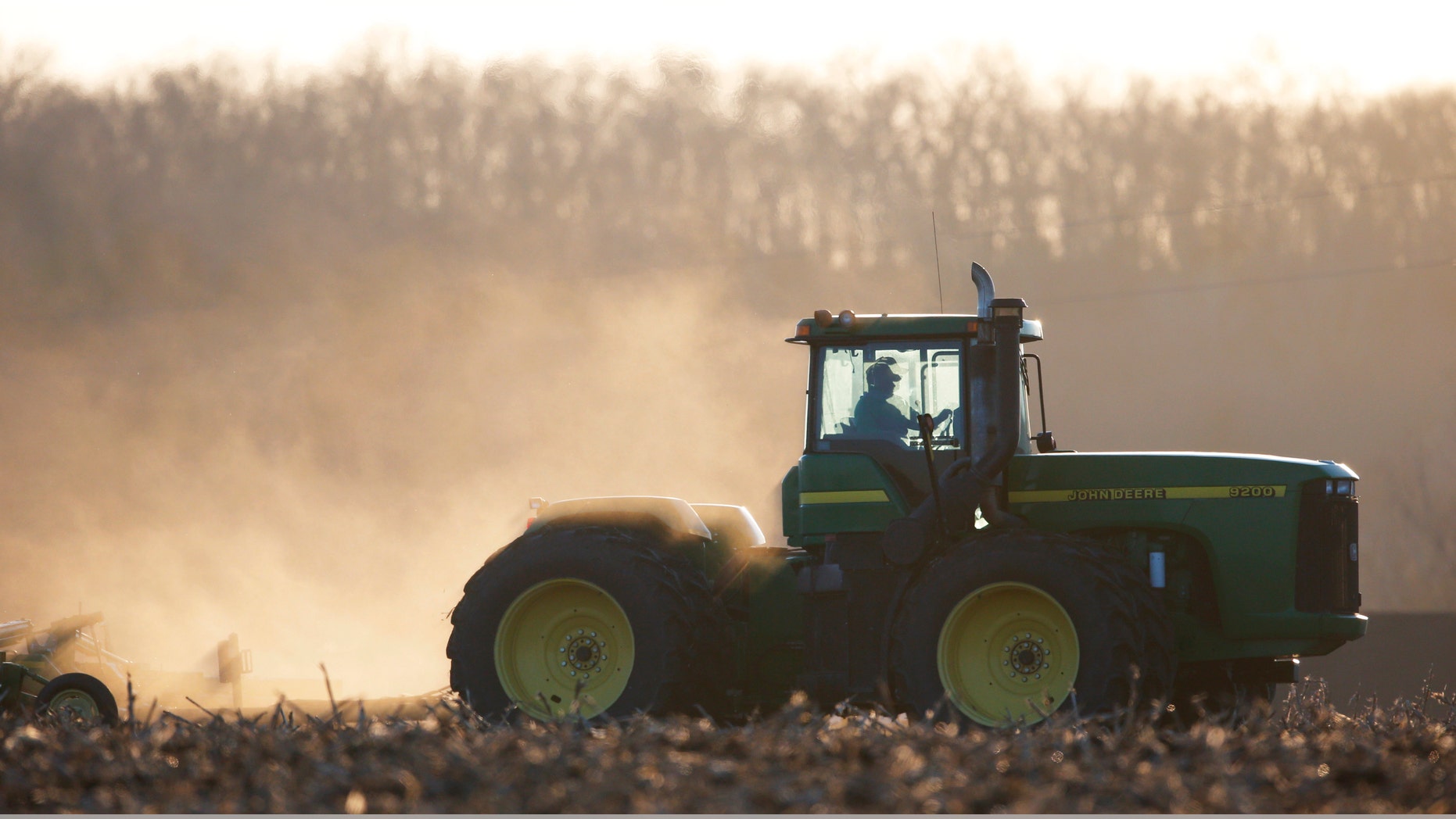 March 19, 2014: A farmer pulls a disc harrow in a field near Tonganoxie , Kan.