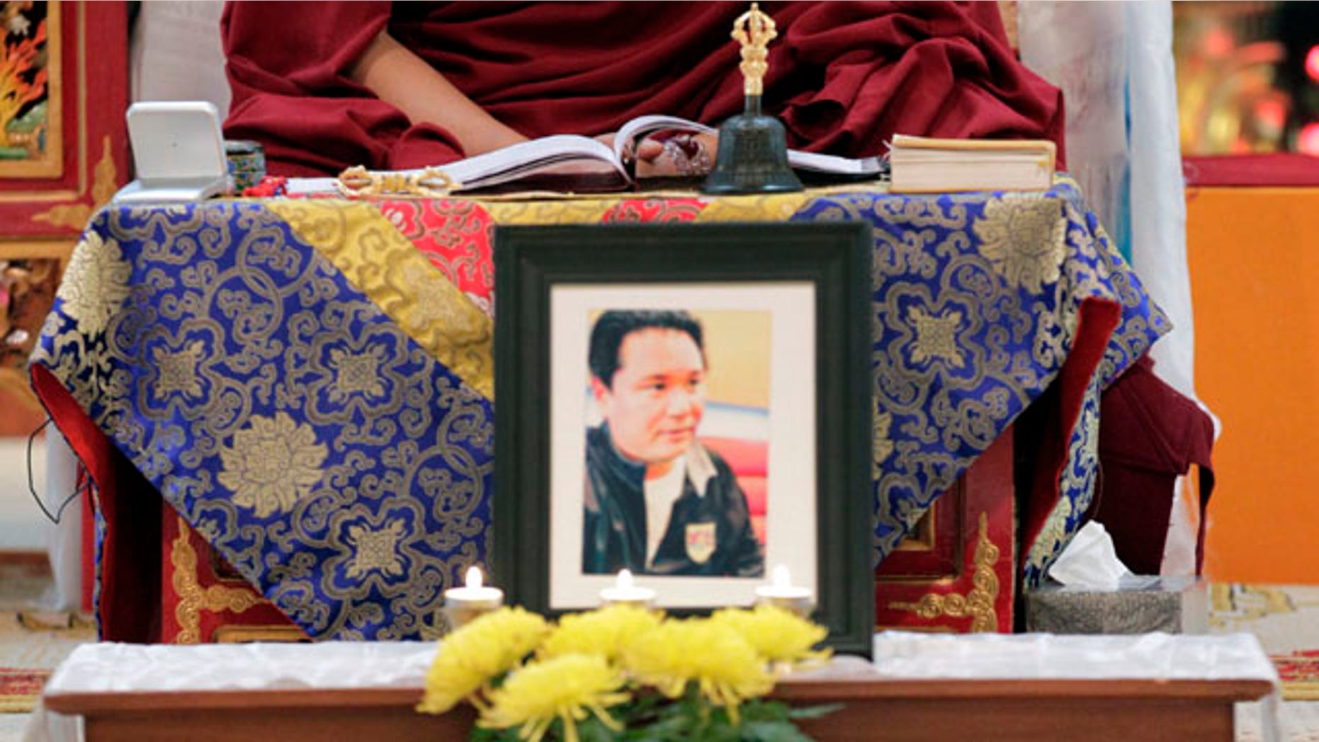Feb. 15: The Venerable Arjia Rinpoche, director of The Tibetan Mongolian Buddhist Cultural Center, says a prayer behind a photograph of Jigme Norbu, the Dalai Lama's nephew, in Bloomington, Ind. Norbu was struck and killed by an SUV along a Florida coastal highway while on a walk to promote Tibetan independence from China.