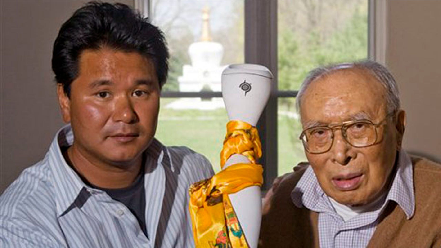 In an April 23, 2008 photo, the Dalai Lama's nephew, Jigme Norbu, left, and brother, Thubten Norbu, hold the Freedom Torch which is carried in protest of China's treatment of Tibetans, at the Tibetan Cultural Center in Bloomington, Ind. Jigme Norbu, 45, of Bloomington, Ind., was struck and killed Monday, Feb. 14, 2011 on a Florida highway at Palm Coast, while on a Valentines Day Walk for Tibet from St. Augustine, Fla. south to West Palm Beach, Fla. Thubten Norbu died Sept. 5, 2008.