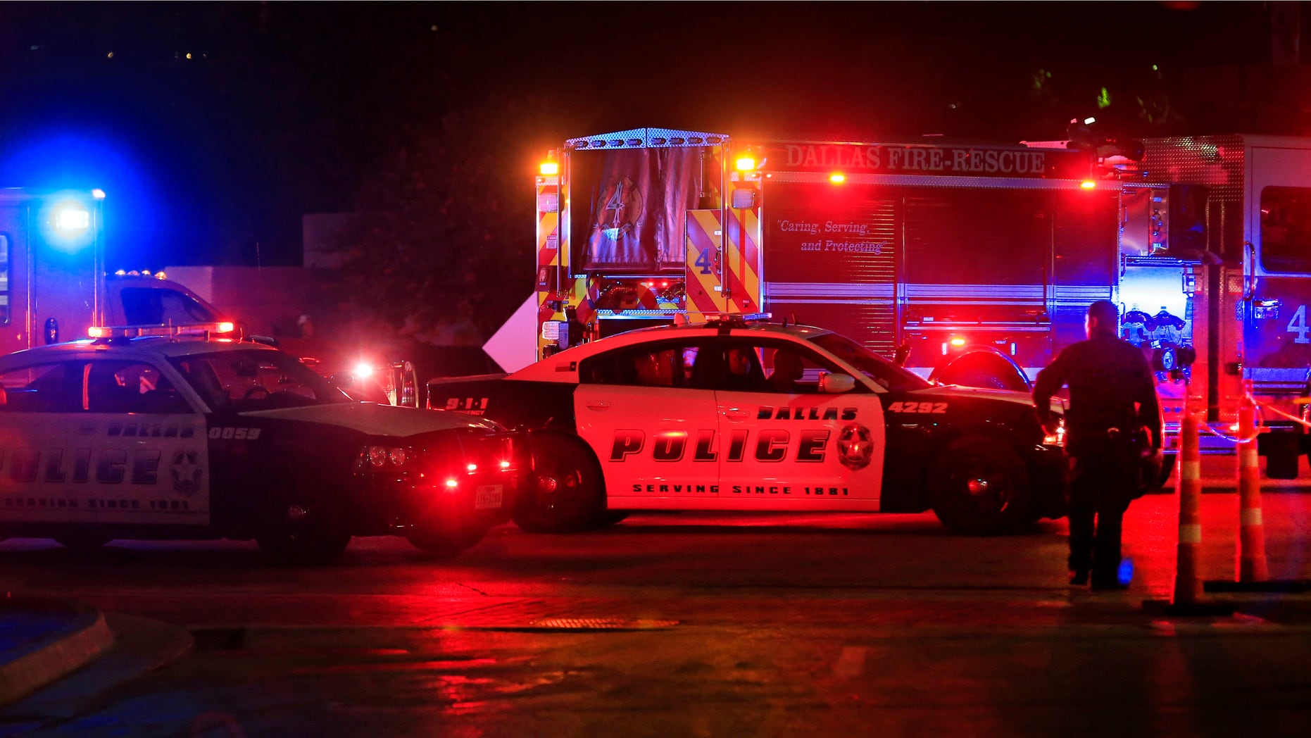 Dallas police work near the scene where eleven Dallas police officers were shot and five have now died on July 8, 2016 in Dallas, Texas. According to reports, shots were fired during a protest being held in downtown Dallas in response to recent fatal shootings of two black men by police - Alton Sterling on July 5, 2016 in Baton Rouge, Louisiana and Philando Castile on July 6, 2016, in Falcon Heights, Minnesota. (Photo by Ron Jenkins/Getty Images)