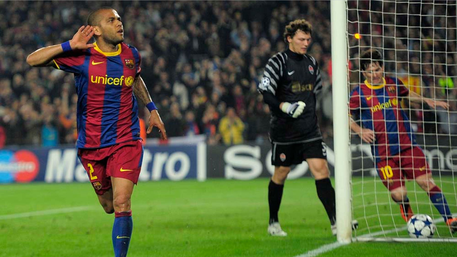 FC Barcelona's Daniel Alves from Brazil, left, reacts after scoring against Shakhtar Donetsk during a quarterfinal first leg Champions League soccer match at the Nou Camp, in Barcelona, Spain, Wednesday, April 6, 2011. (AP Photo/Manu Fernandez)