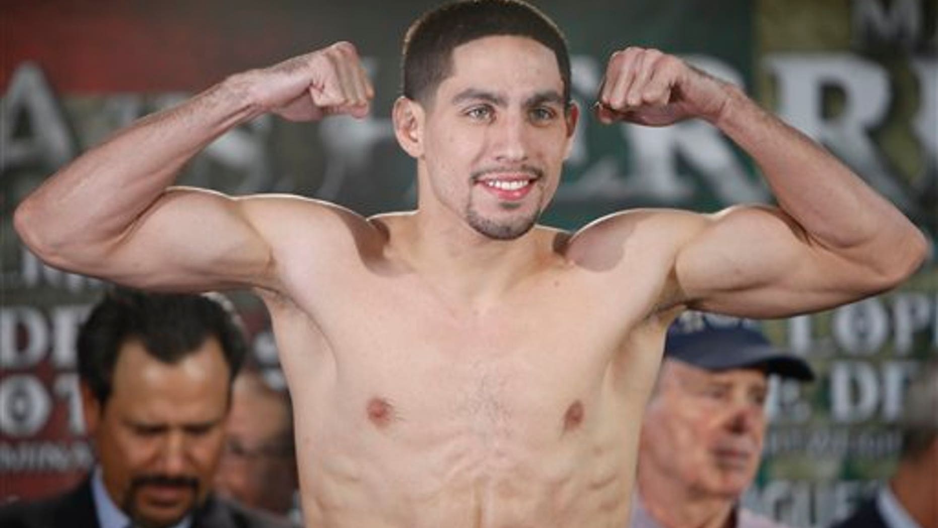 Unified Super Lightweight World Champion Danny "Swift" Garcia poses for photos as he makes weight during the official weigh-in at the Ruben Rodriguez Coliseum in Bayamon, Puerto Rico, Friday, March 14, 2014. Garcia will defend his title against Mauricio "El Maestro" Herrera on Showtime Championship Boxing's main event Saturday. (AP Photo/Ricardo Arduengo)
