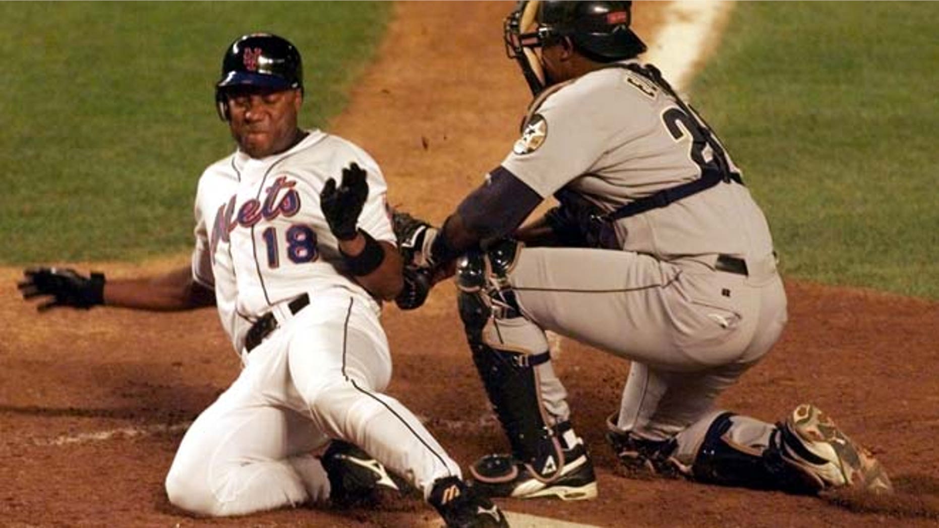 Aug. 23, 1999: New York Mets' runner Darryl Hamilton (L) is out at the plate on a tag by Houston Astros' catcher Tony Eusebio in the fourth inning at New York's Shea Stadium.